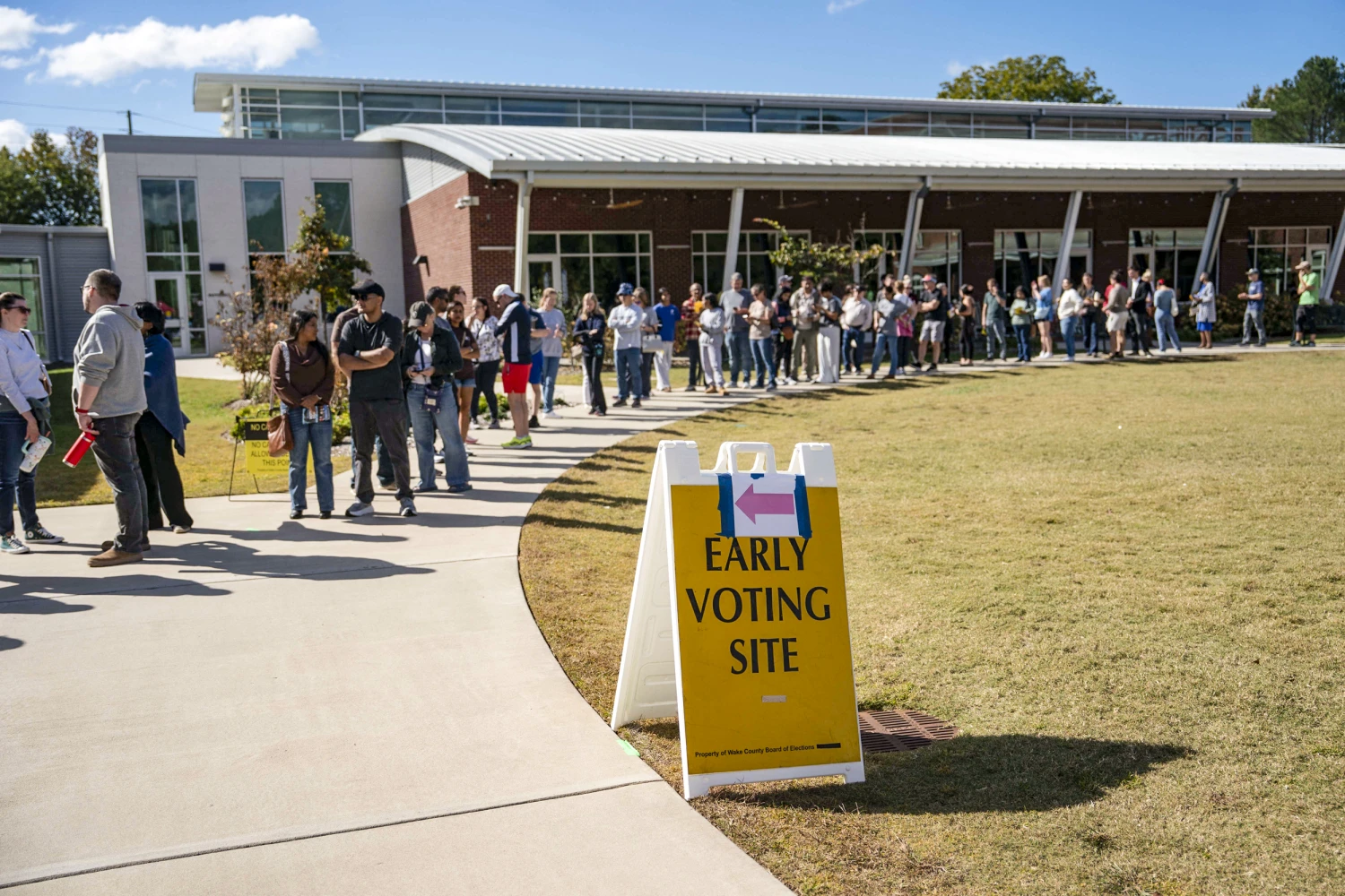 People wait in line for early voting for the midterm elections on Oct. 25, 2026 in Cary, N.C.