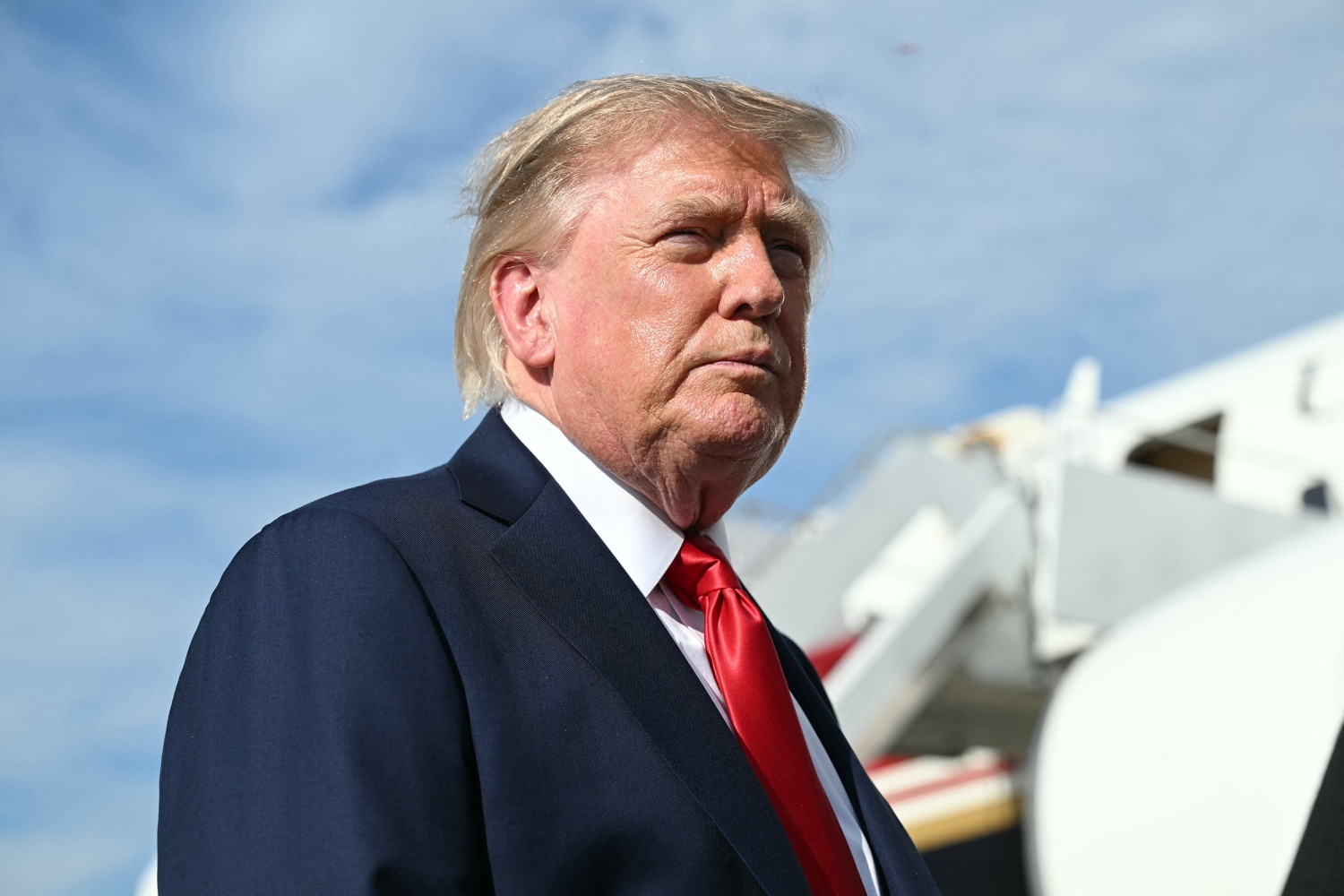 President Donald Trump looks on as he speaks to reporters before boarding Air Force One at Joint Base Andrews, Maryland on August 21, 2026.