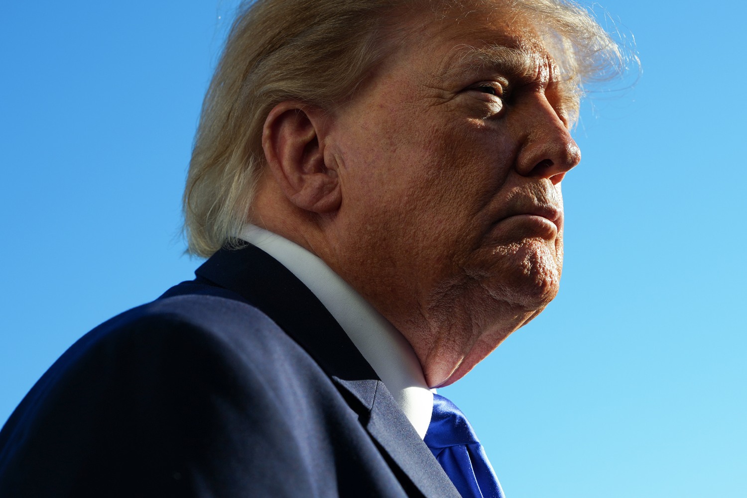 President Donald Trump stops to speak to members of the media as he departs on the South Lawn of the White House on October 22, 2026 in Washington, DC.