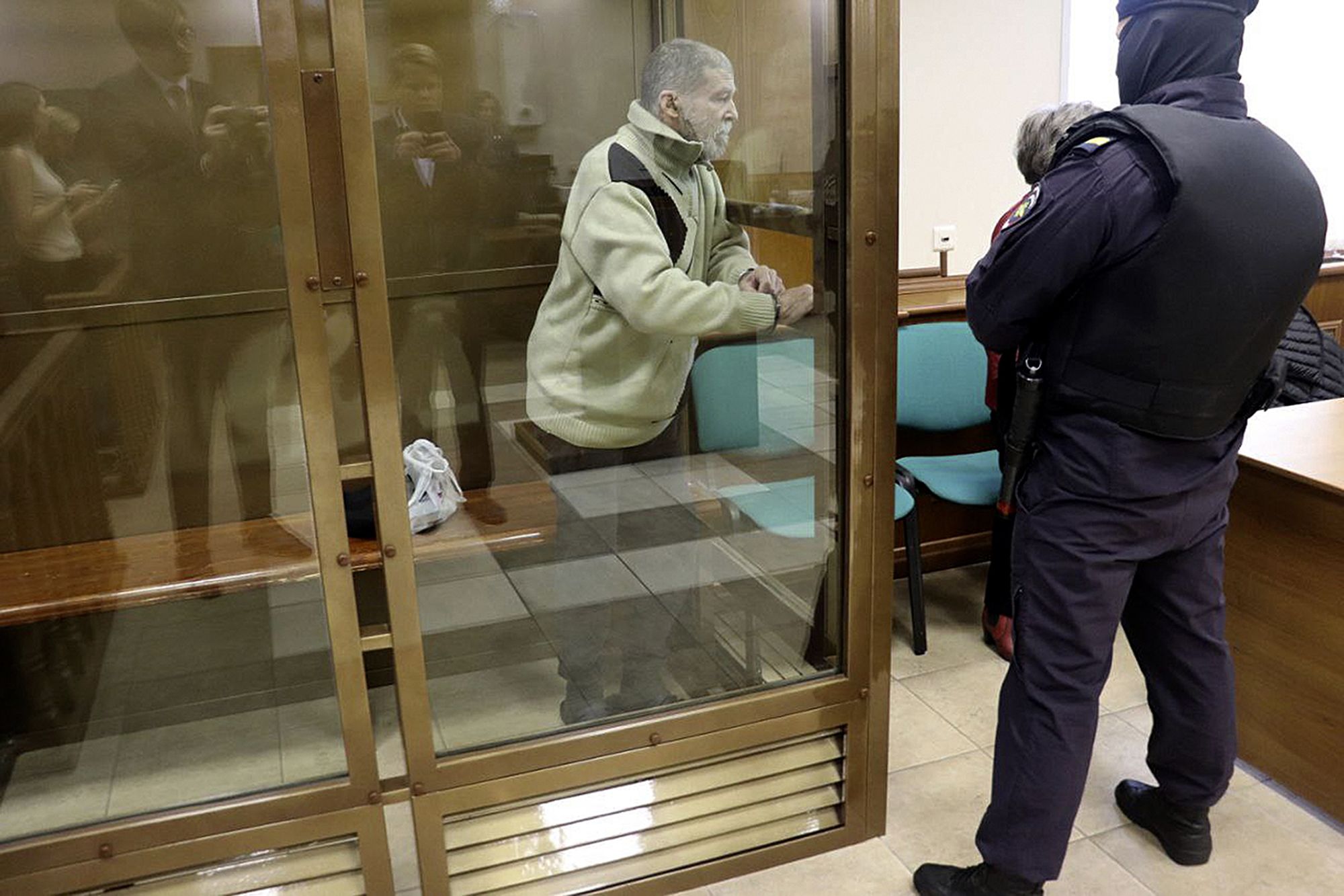 In this photo released by the Moscow City Court Press Service, Stephen Hubbard, a US citizen accused of fighting as a mercenary in Ukraine against Russia stands in a glass cage during a court session in the Moscow City court on Monday, Oct. 7, 2024.