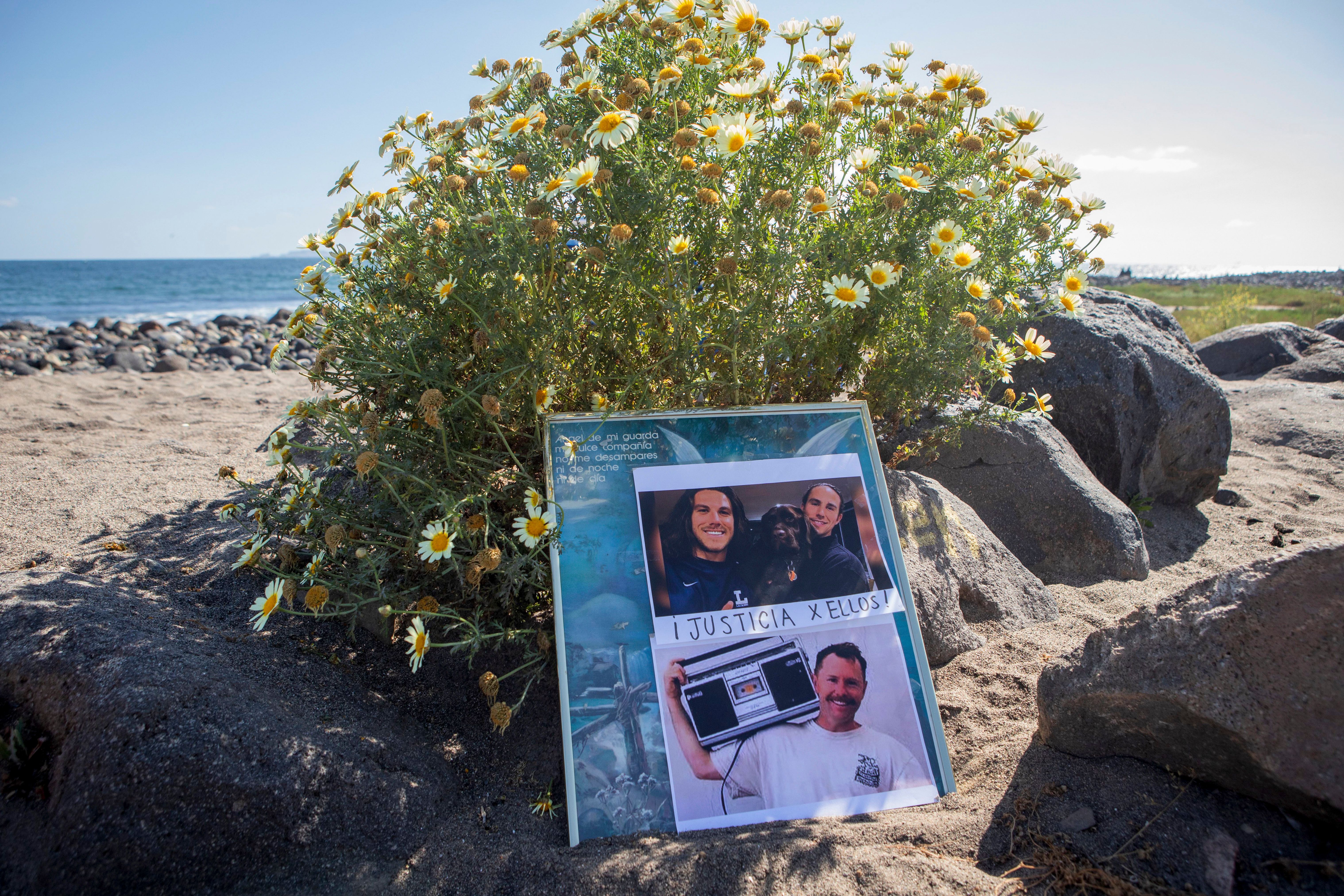 The photos of foreign surfers who disappeared are displayed on a poster on the beach in Ensenada, Mexico, on May 5, 2024.