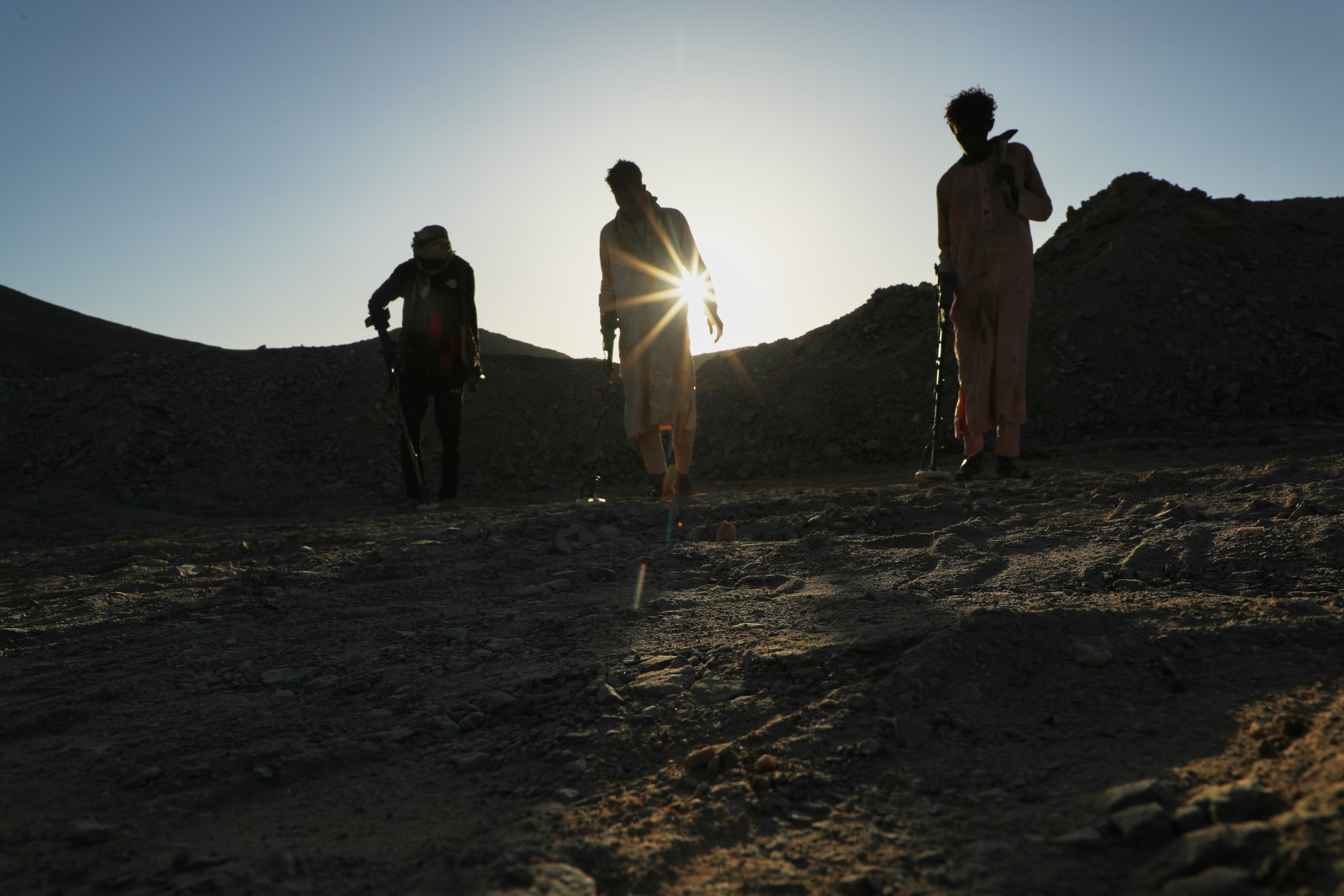 Miners use metal detectors to search for gold at an artisanal mining site in Dalago Mahas, northern Sudan, on May 7, 2026.