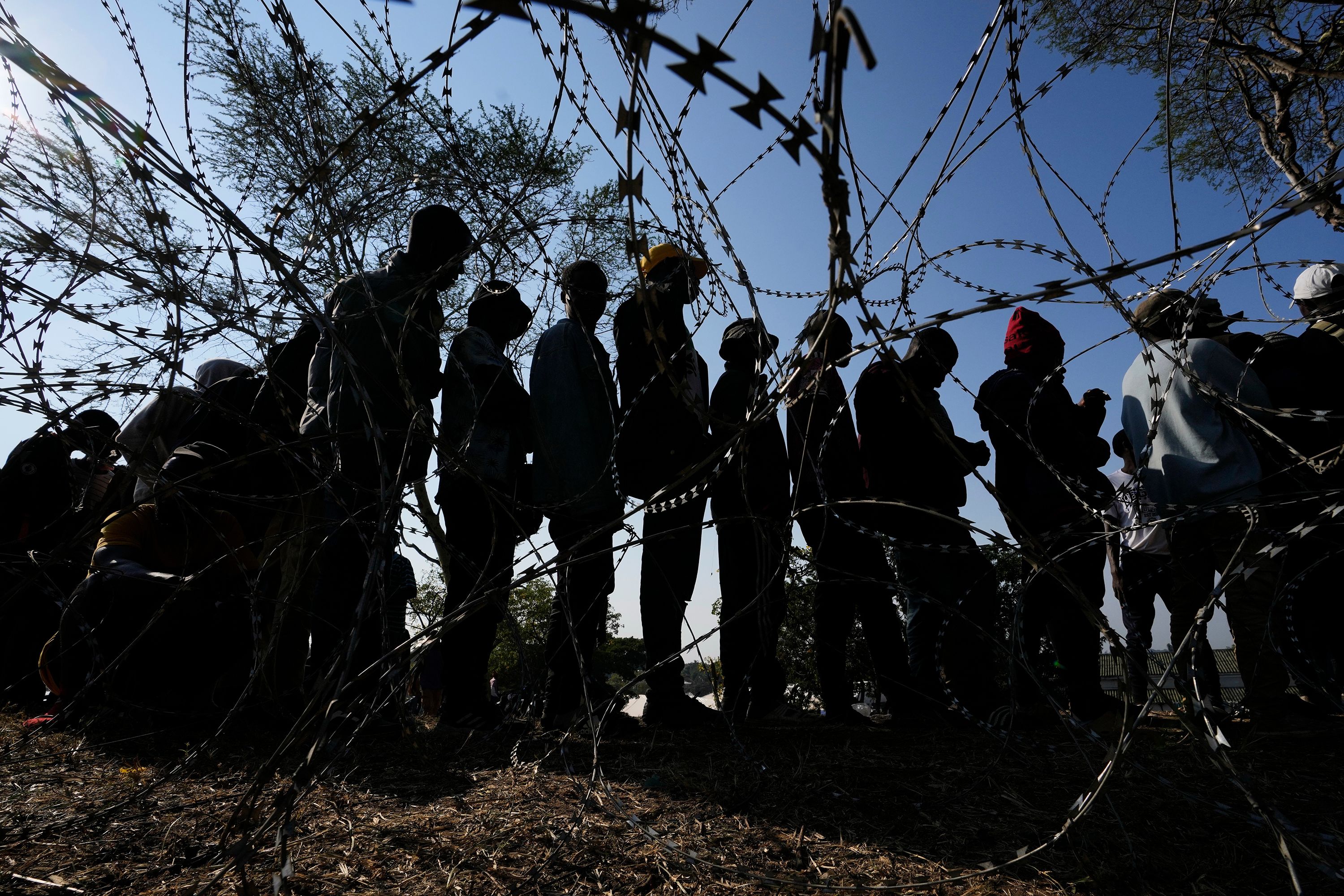 Malawian migrants stand in a queue for their deportation at a temporary centre, in Durban, South Africa, on June 18.