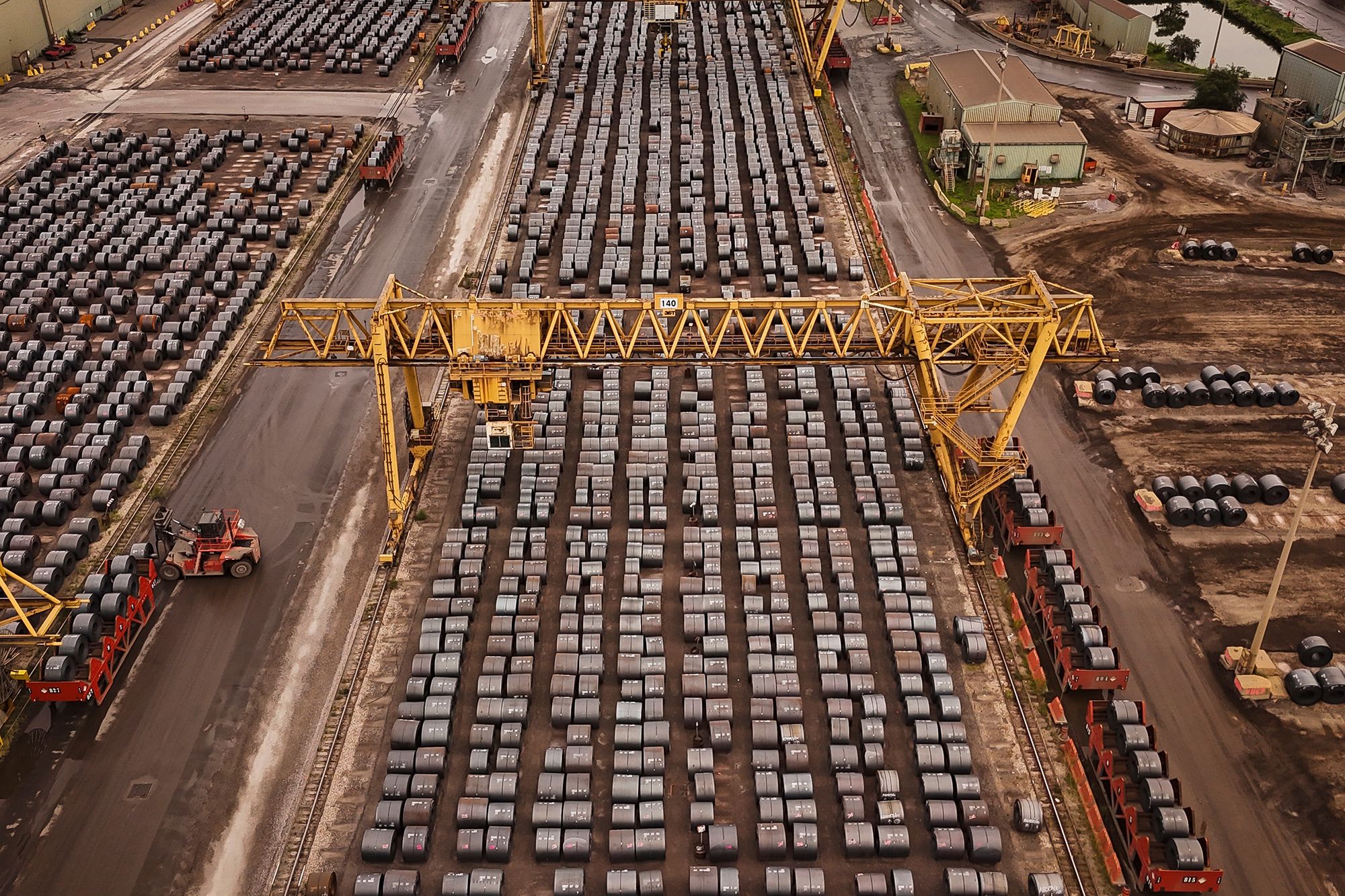 Rolled coils of steel sit in the yard at the ArcelorMittal Dofasco steel plant in Hamilton, Ontario, on August 20, 2026.
