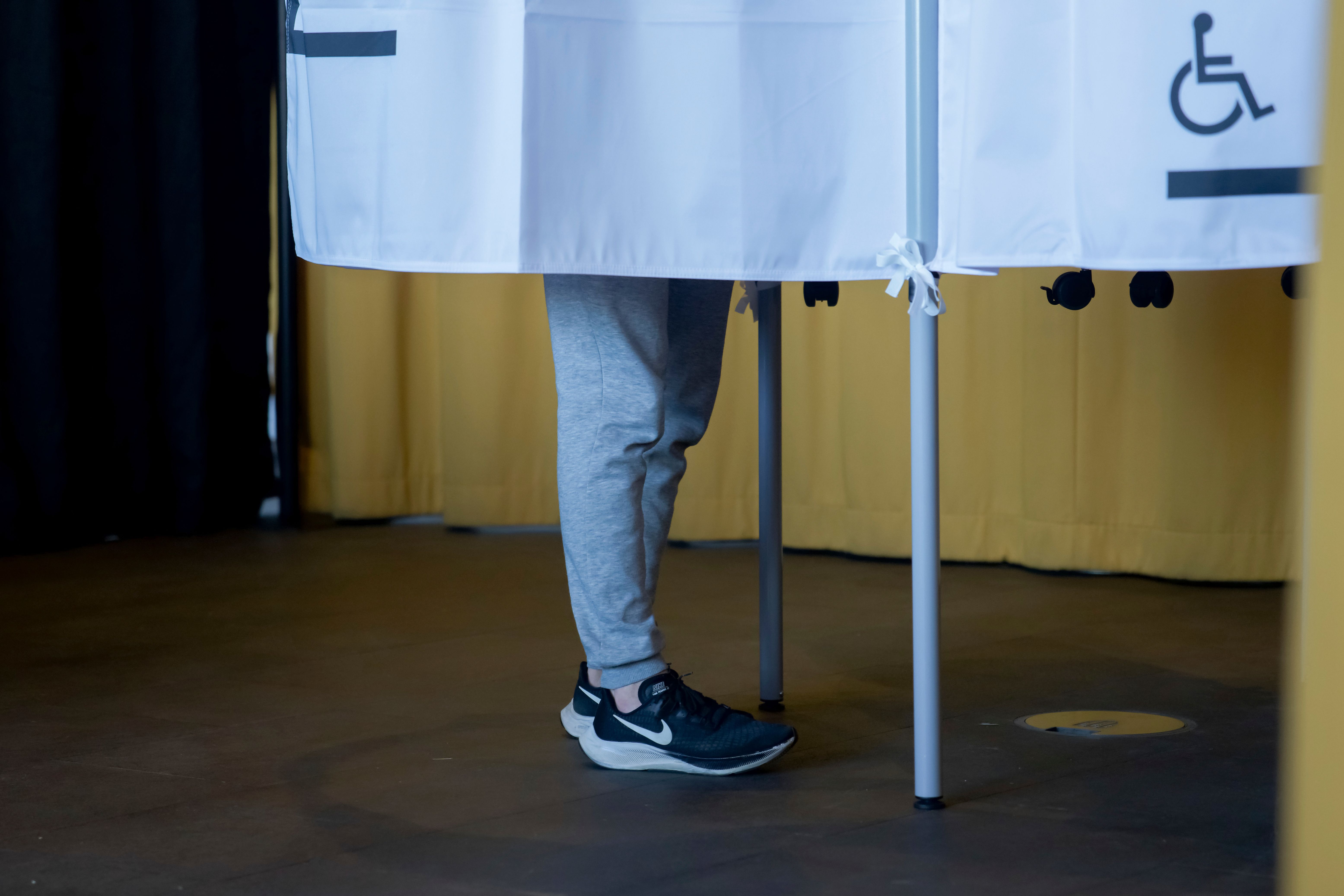 A voter casts a ballot behind a voting screen at Reykjavik City Hall in Reykjavik, Iceland, on Saturday, August 29, 2026.