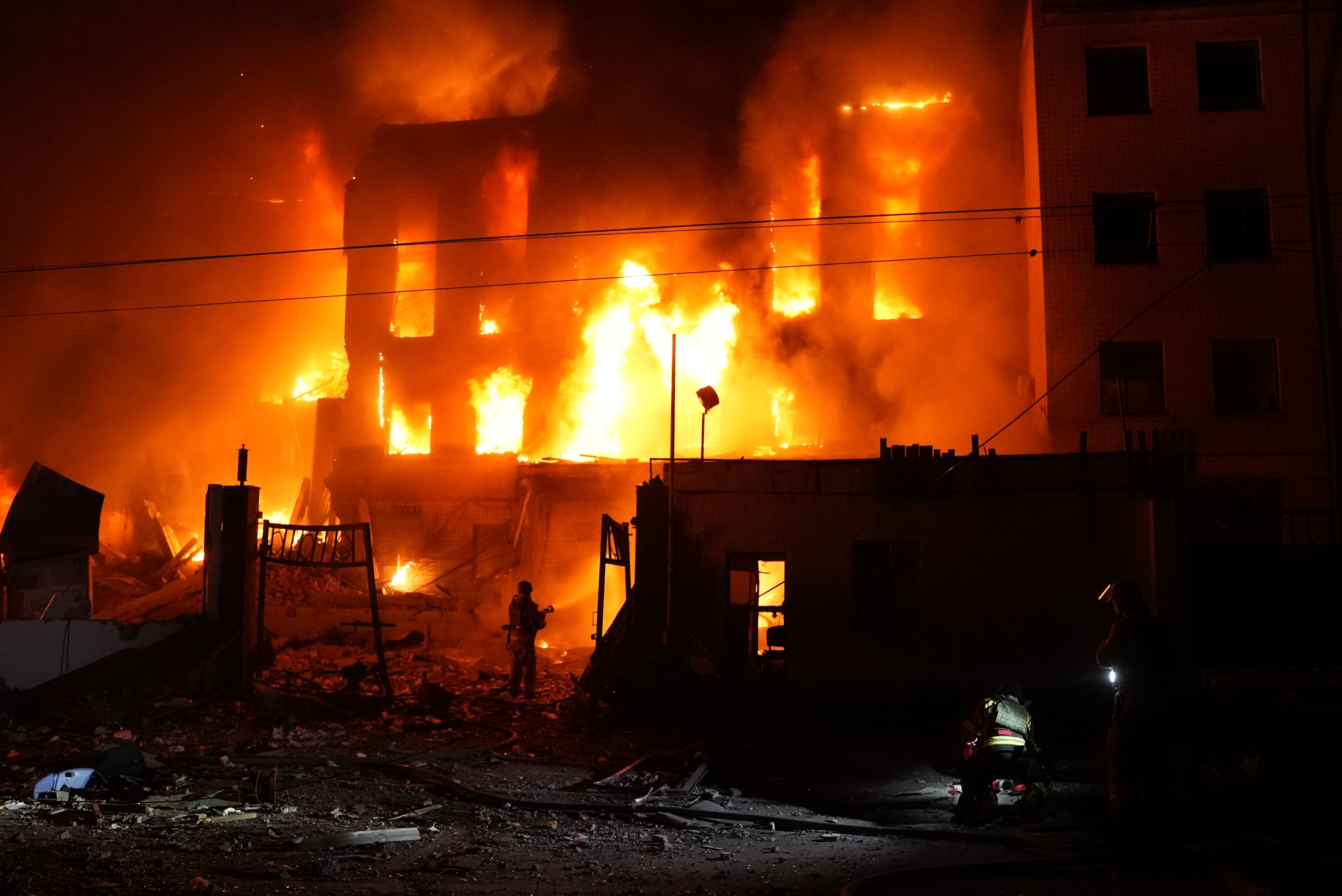 A rescue worker puts out a fire of a building destroyed after a Russian missile attack in Kyiv, Ukraine, on September 8, 2026.
