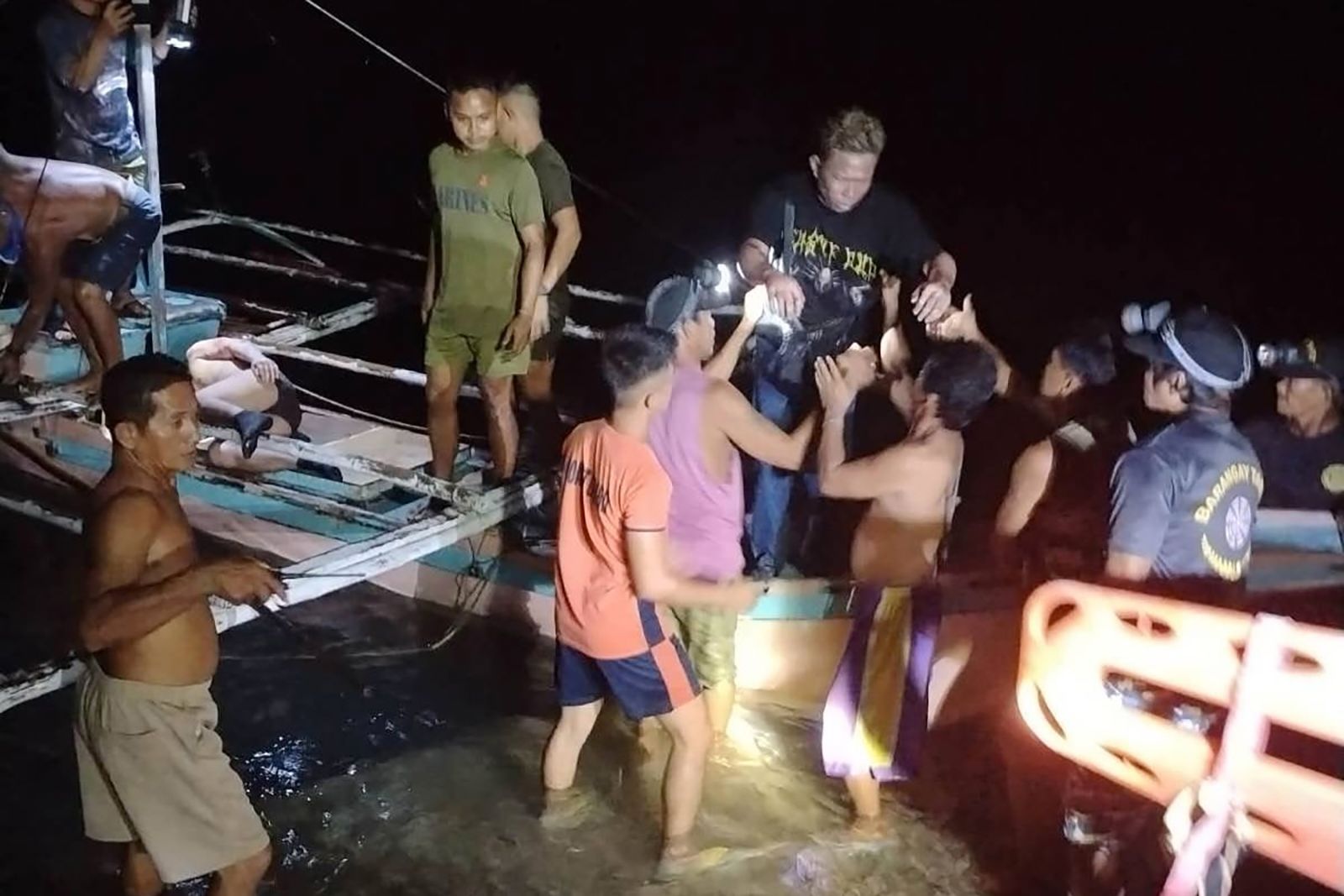 A survivor is assisted off a small boat after being rescued from a burning ferry off Palawan province, Philippines on Wednesday Sept. 9, 2026.
