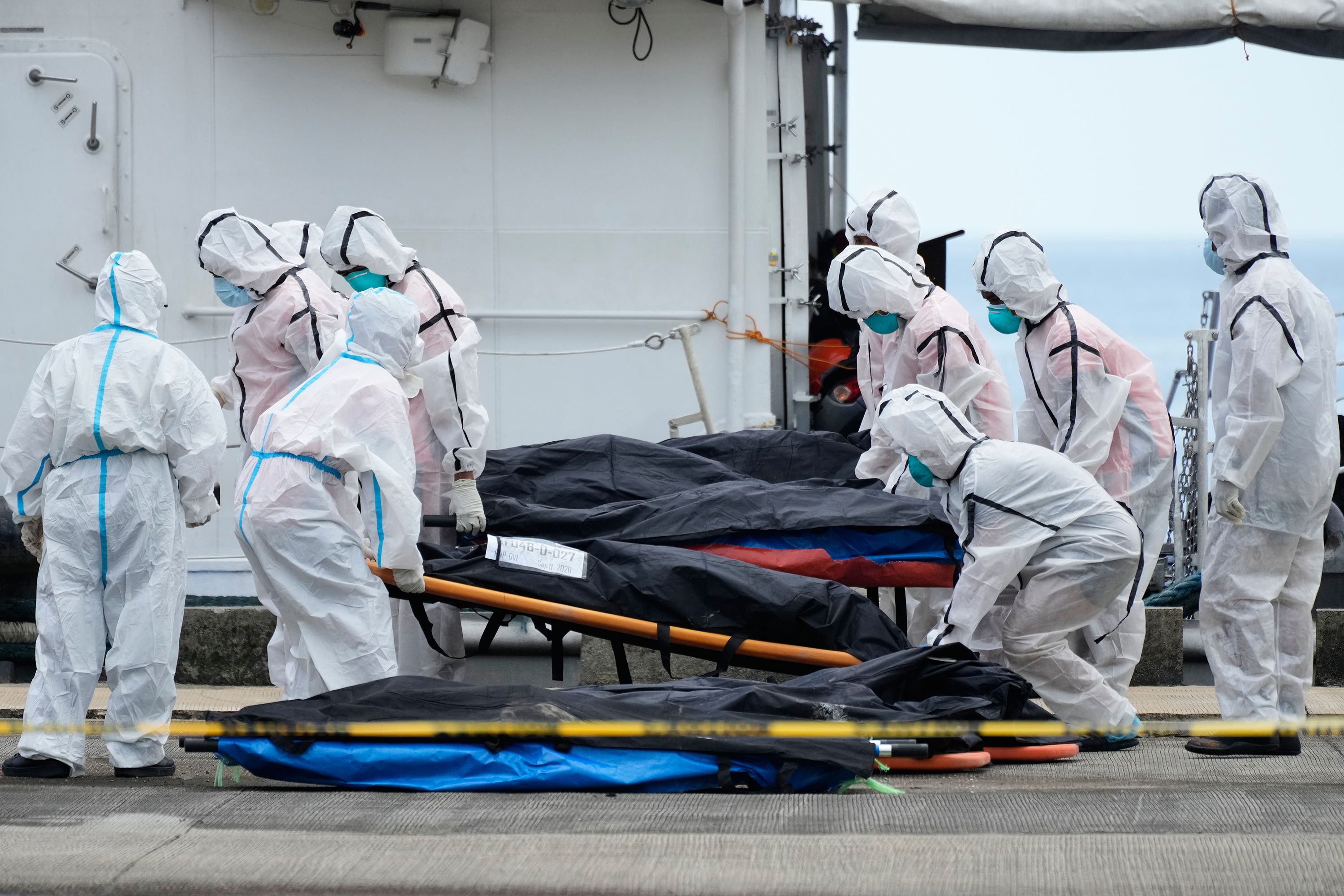 Rescuers carry the remains of victims of the recent fire on the MV June Aster ferry as they arrive on board a Philippine Coast Guard vessel at the Borac port in Coron, Palawan province, western Philippines on, Saturday, Sept. 12, 2026. (AP Photo/Aaron Favila)