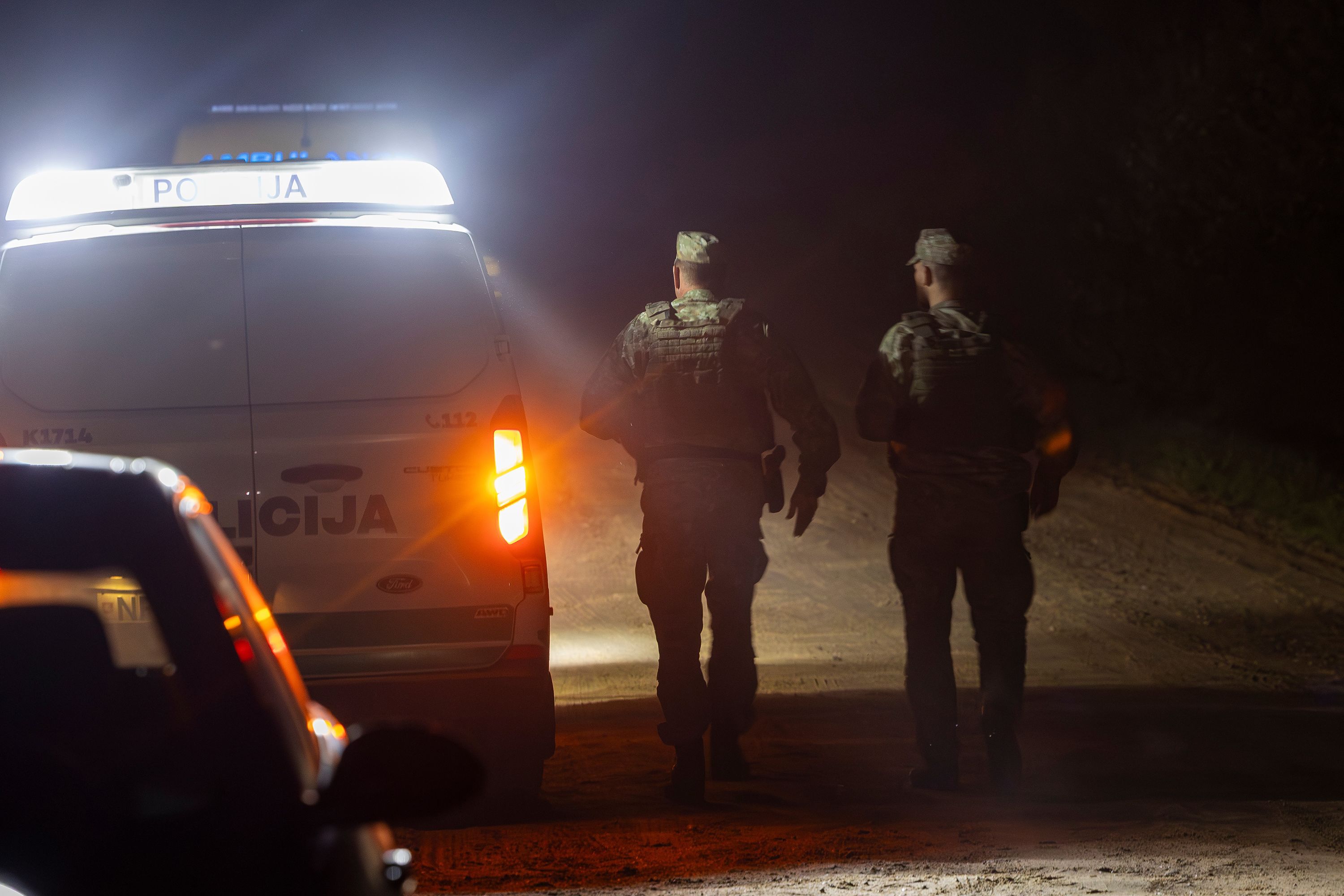 Lithuanian soldiers secure the area where a NATO fighter jet shot down a drone equipped with an explosive device early on Tuesday morning near Pratkunai village, Lithuania.