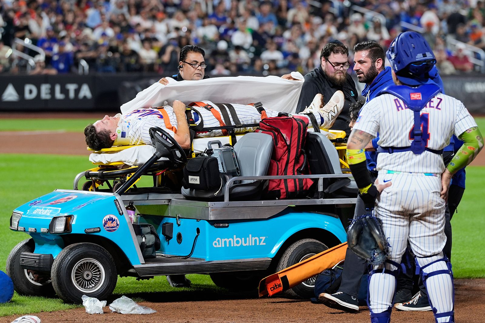 Mets first baseman Jared Young is brought off the field on a stretcher after colliding with pitcher Nolan McLean during the sixth inning of Thursday's game against the Phillies in New York.