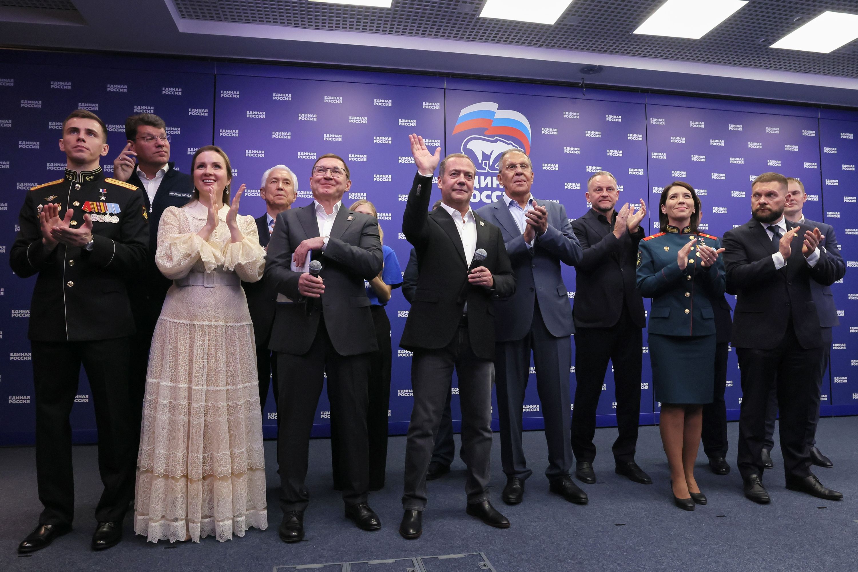Russian Security Council Deputy Chairman and the head of the United Russia party Dmitry Medvedev, center, and Russian Foreign Minister Sergey Lavrov, center right, stand with other party members as they watch preliminary voting results for Russian parliamentary elections at the United Russia's headquarters in Moscow, Russia, Sunday, Sept. 20, 2026. (Ekaterina Shtukina, Sputnik, Kremlin Pool Photo via AP)