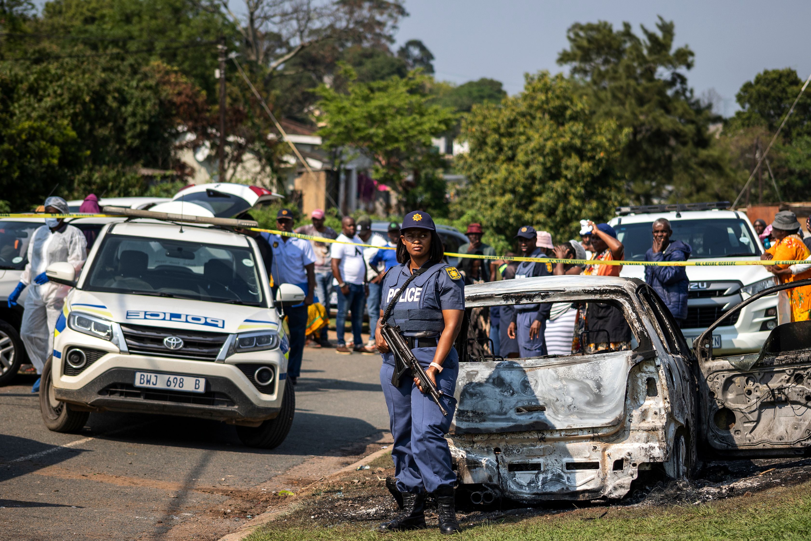 A police officer stands at the scene of a mass shooting at a house party in KwaMakhutha township south of the city of Durban, South Africa, onSeptember 23, 2026.