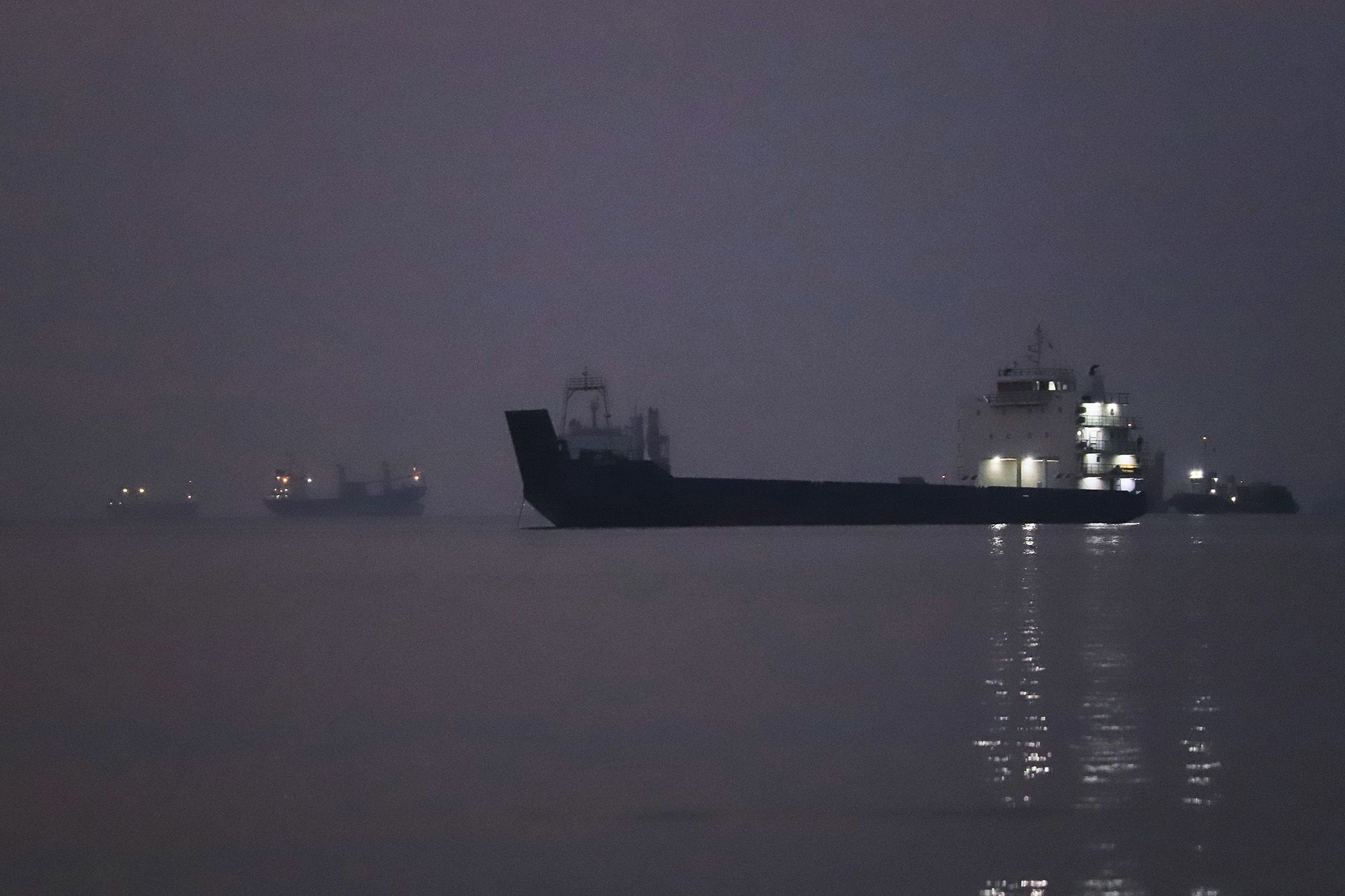 Cargo ships are anchored in the Strait of Hormuz off Bandar Abbas, Iran, before sunrise Monday, Sept. 28, 2026.