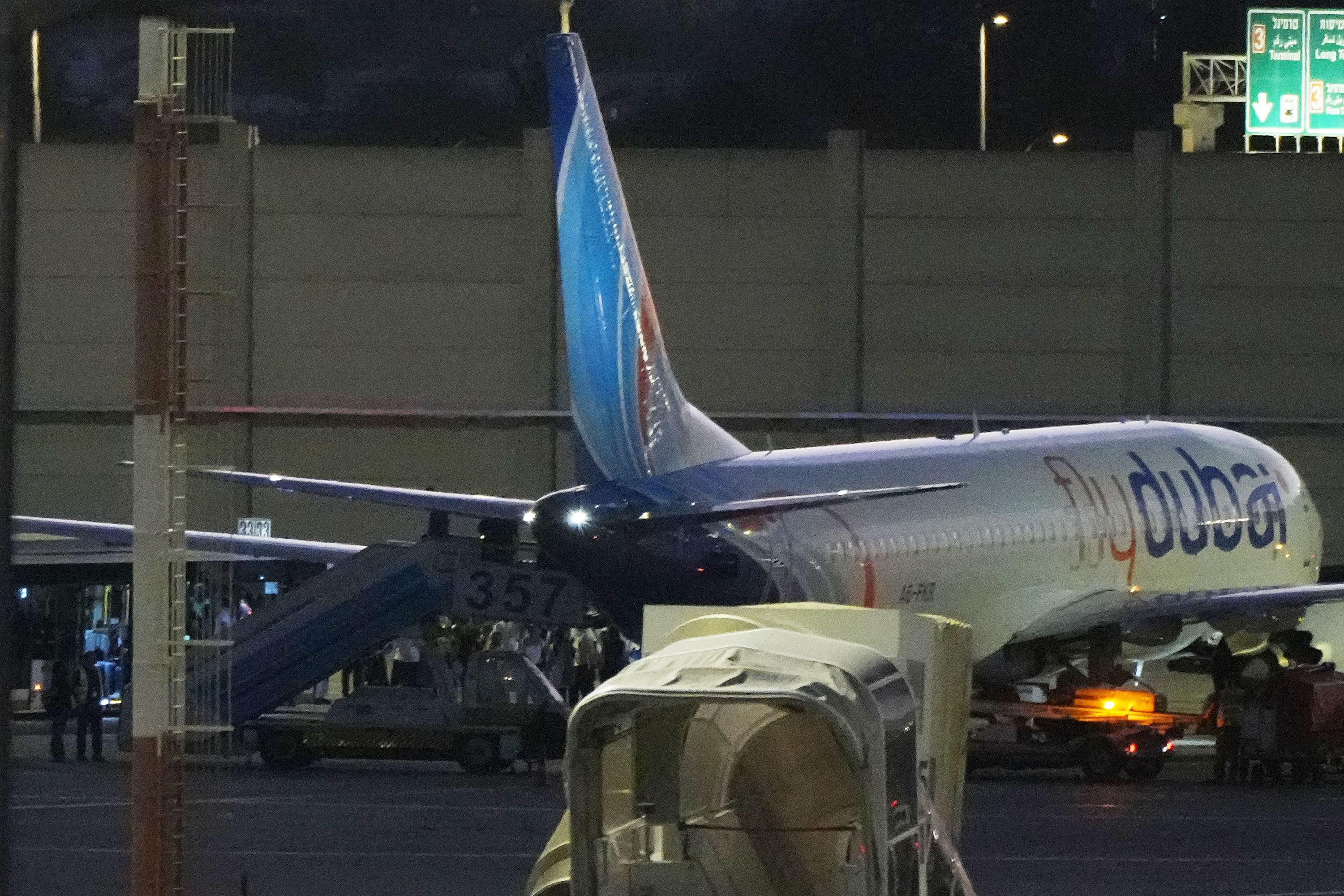 People disembark from a FlyDubai carrying Israeli passengers who had earlier been aboard another FlyDubai aircraft that made an emergency landing in Saudi Arabia approaches Ben Gurion International Airport near Tel Aviv, Israel, Wednesday, Sept. 30, 2026. (AP Photo/Ariel Schalit)