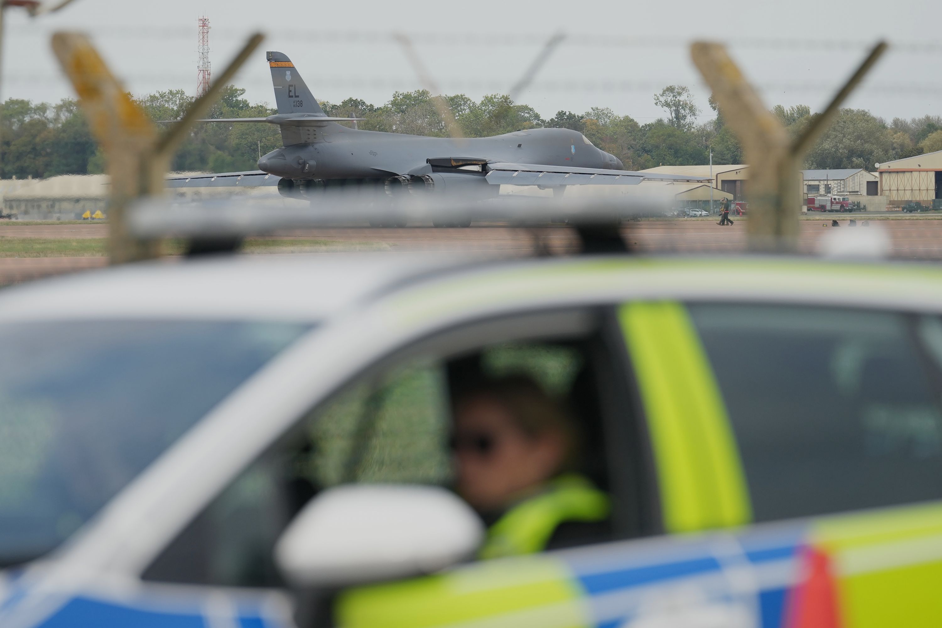 A B1 bomber prepares to take off as police officers guard a checkpoint near RAF Fairford in Fairford, England, on September 29.