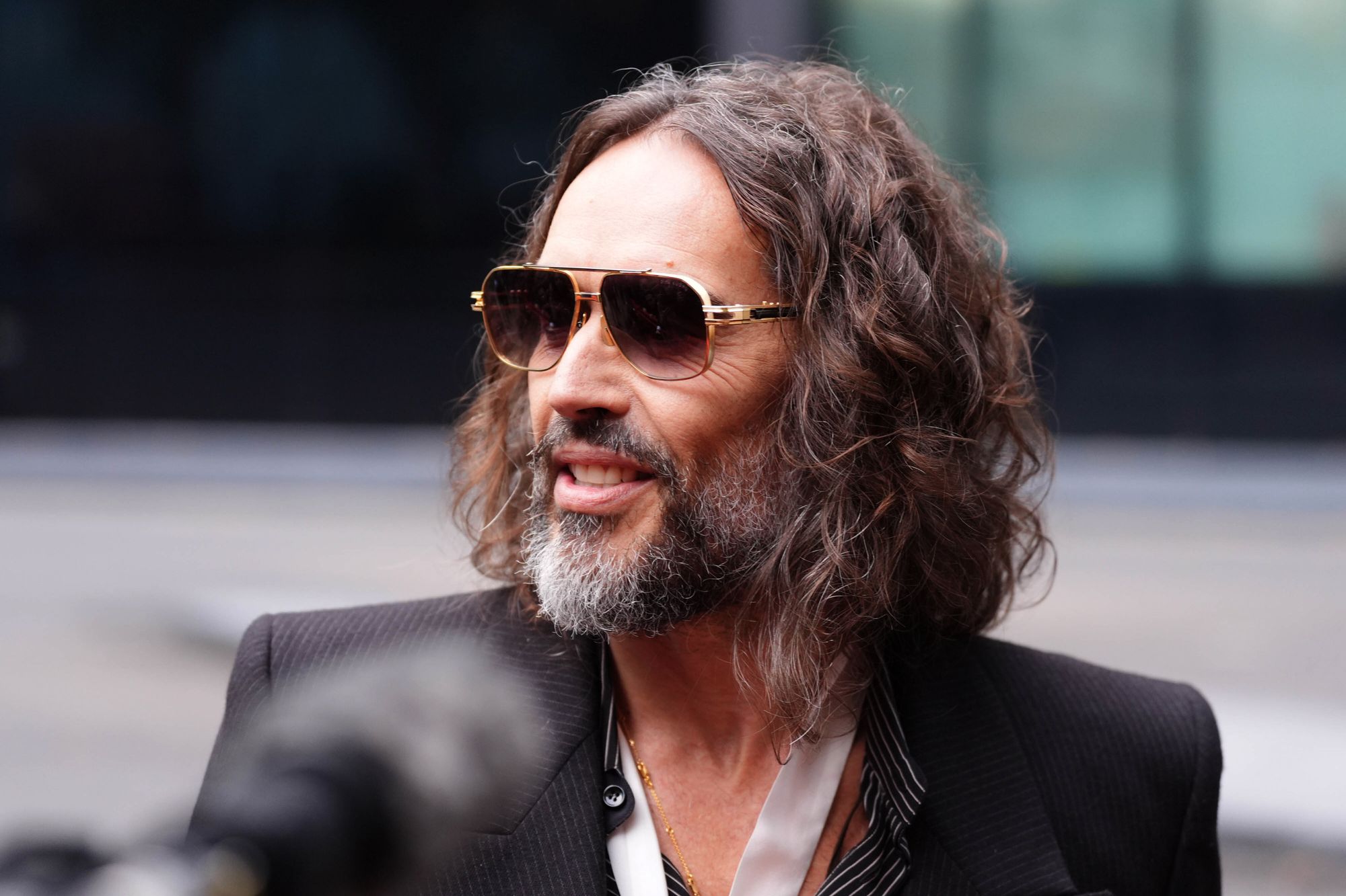 British comedian Russell Brand speaks to the media as he arrives at Southwark Crown Court in London on Wednesday.