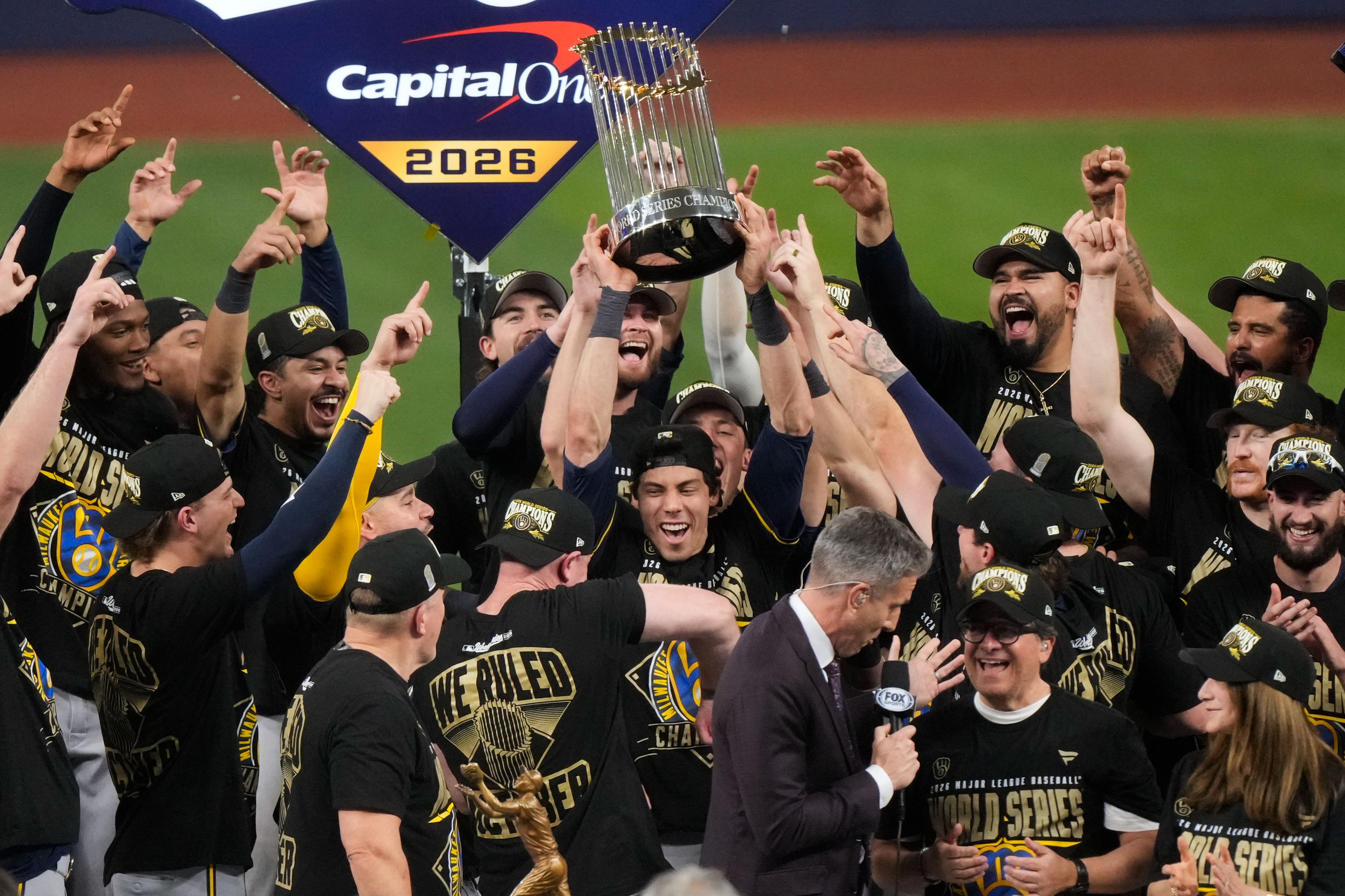 Milwaukee Brewers designated hitter Christian Yelich holds the World Series trophy with teammates after winning baseball's World Series, against the Tampa Bay Rays, Wednesday, Oct. 28, 2026, in St. Petersburg, Fla. (AP Photo/Morry Gash)