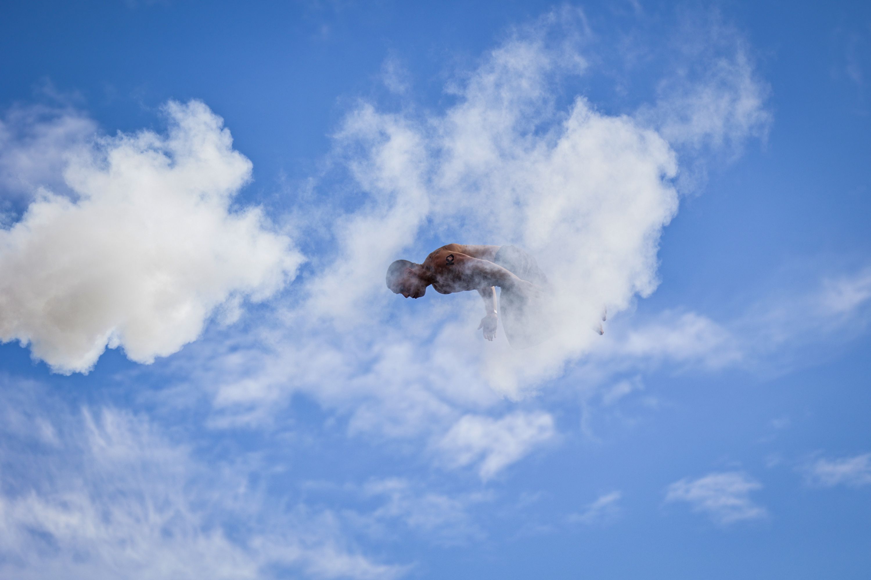 Reagan Popoff from the US is seen behind a cloud of fog as he competes in the World Death Diving Championship held in Arendal in Norway on August 22, 2026. The athletes dive from a 13-meter high tower, competing to showcase the boldest style in the air and upon entry into the water. (Photo by Tor Erik Schrøder / NTB / AFP via Getty Images) / Norway OUT