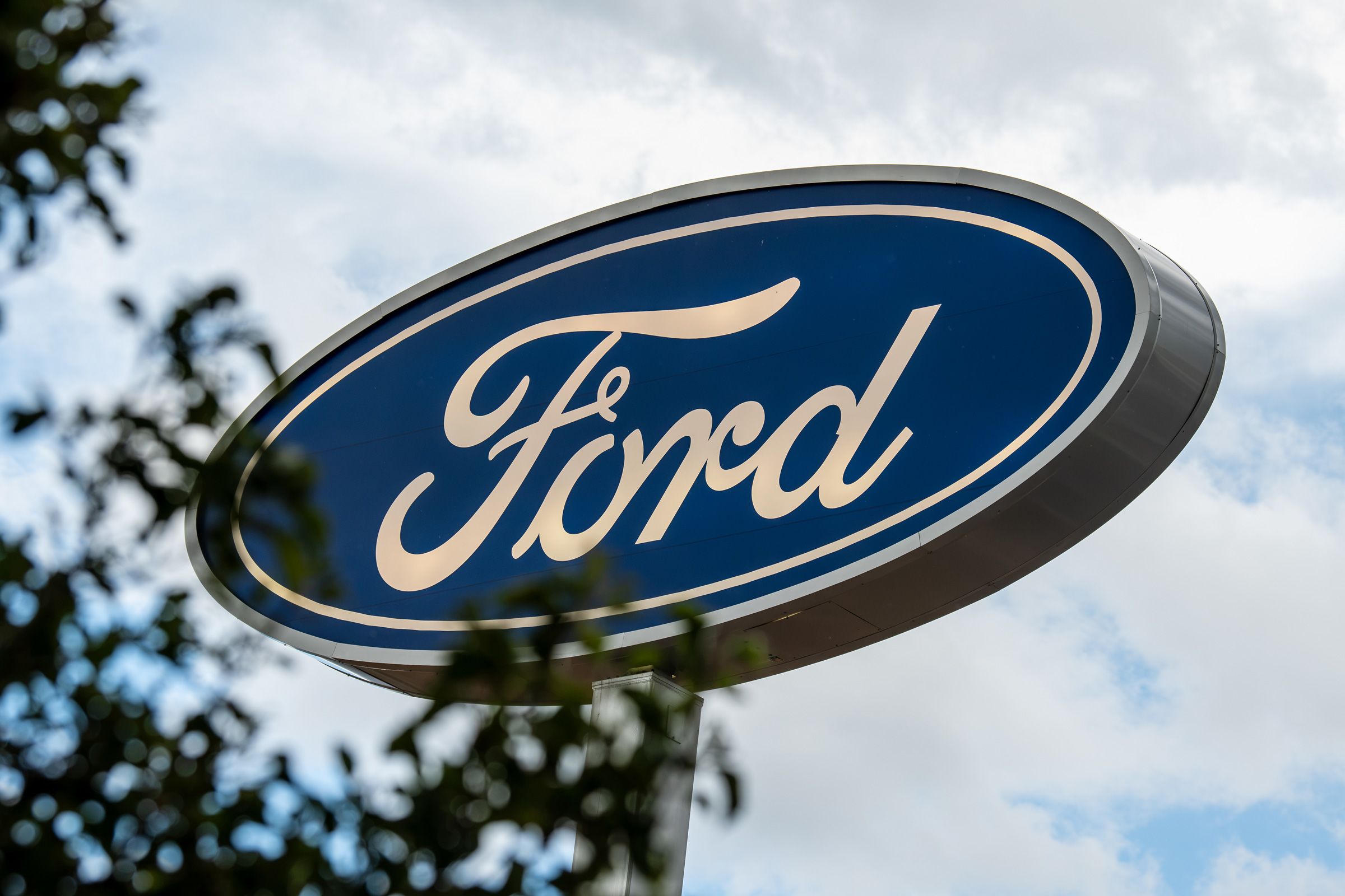 A low-angle close-up view shows the corporate Ford Blue Oval logo signage in Santaquin, Utah, on August 30, 2026.