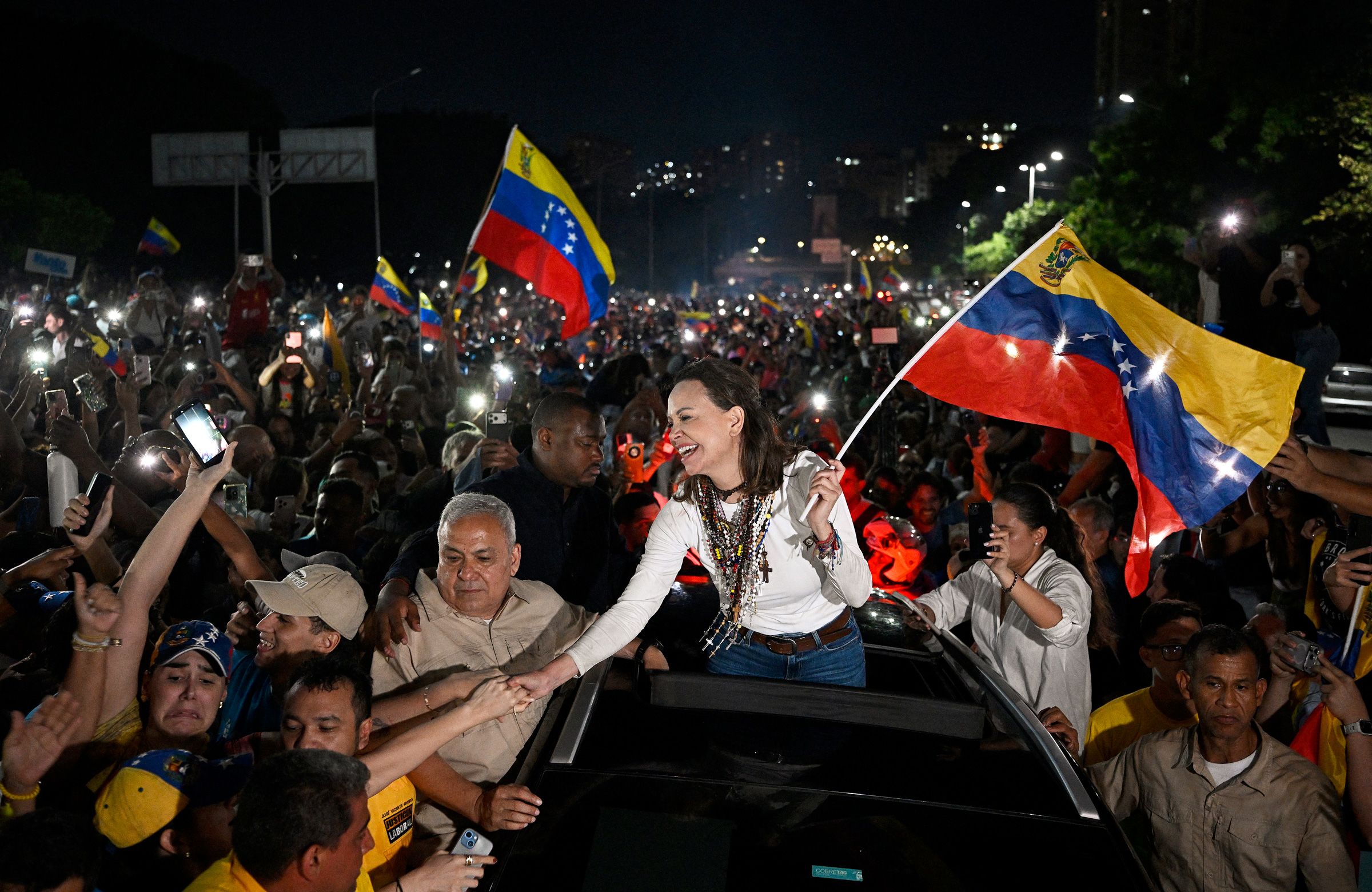 Venezuelan opposition leader and Nobel Peace Prize laureate Maria Corina Machado greets supporters upon her arrival in Caracas on October 25.
