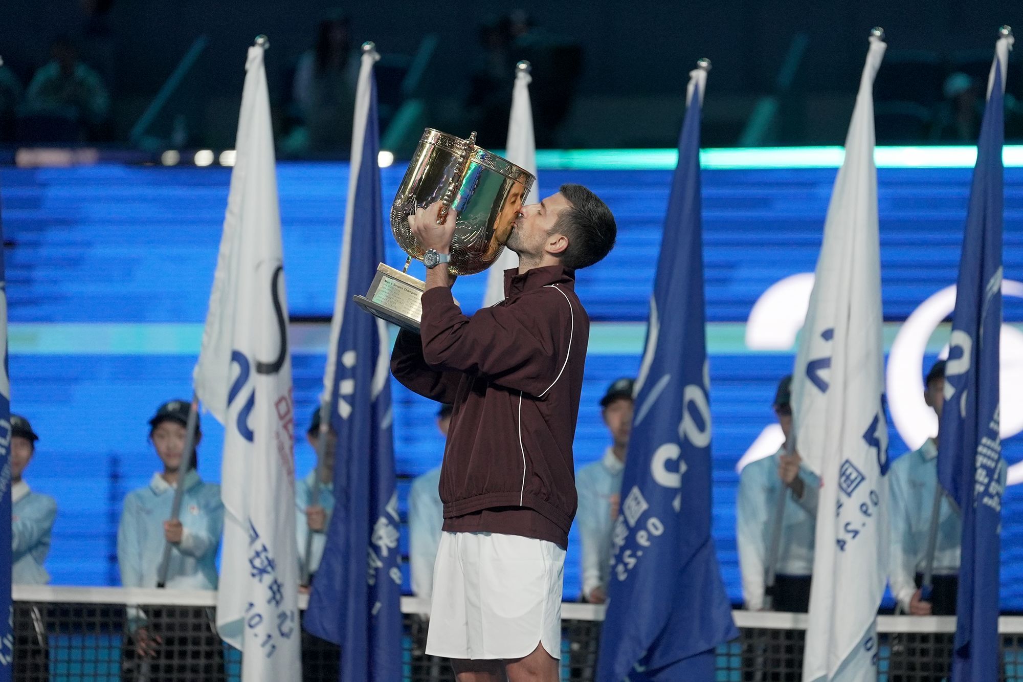 Serbia's Novak Djokovic holds up the trophy as he celebrates winning the men's singles final against Australia's Alex de Minaur at the China Open tennis tournament in Beijing on October 6, 2026.