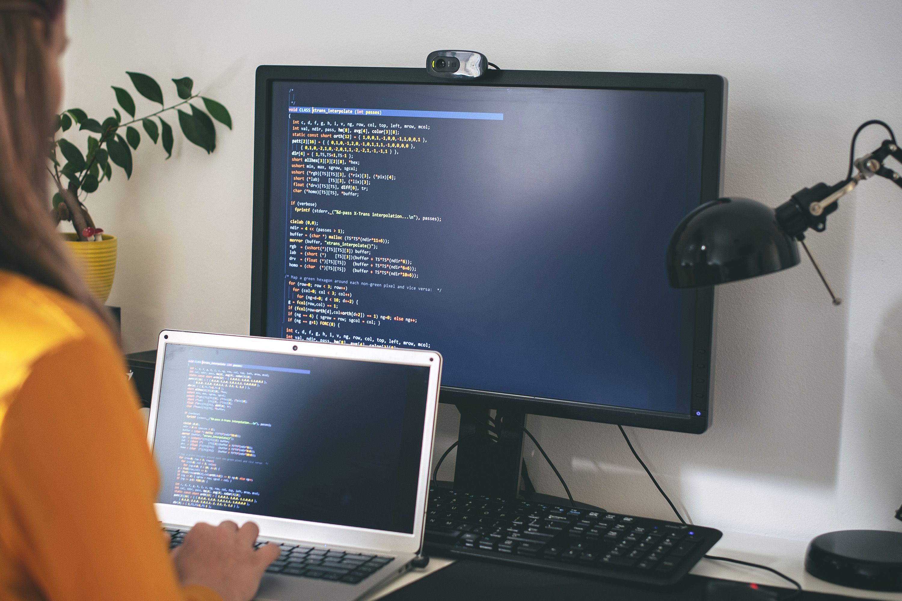 A programmer works at home in their office.