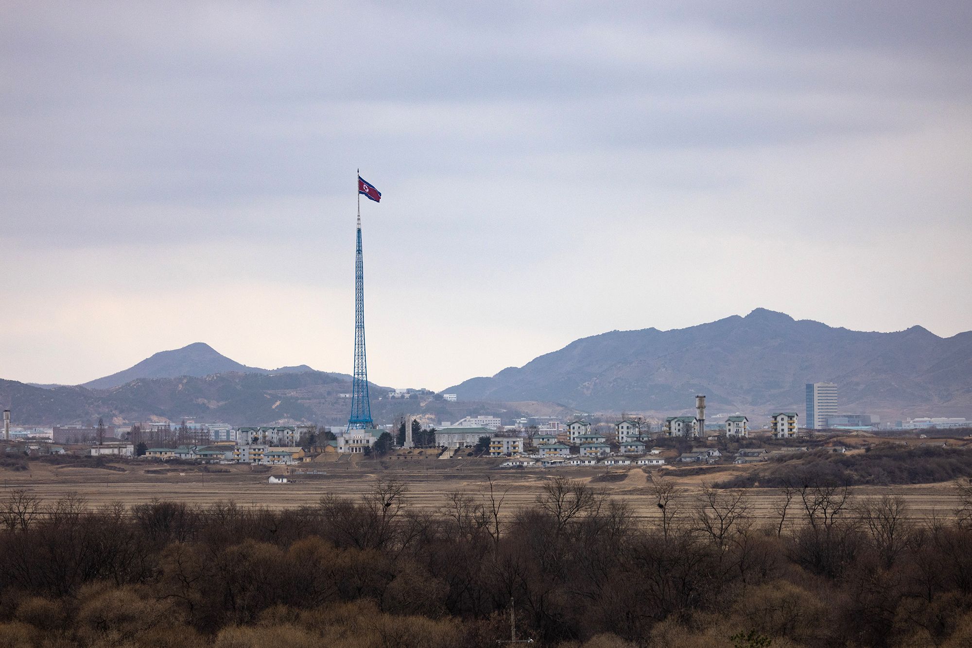 A North Korean flag flies above North Korea's Gijungdong village, from the truce village of Panmunjom in the Demilitarized Zone (DMZ) in Paju, South Korea, on Friday, March 3, 2023. The US and South Korea plan to hold large-scale military drills in a move set anger Pyongyang, which has promised an unprecedented response to the exercises and threatened to turn the Pacific Ocean into its "firing range." Photographer: SeongJoon Cho/Bloomberg via Getty Images