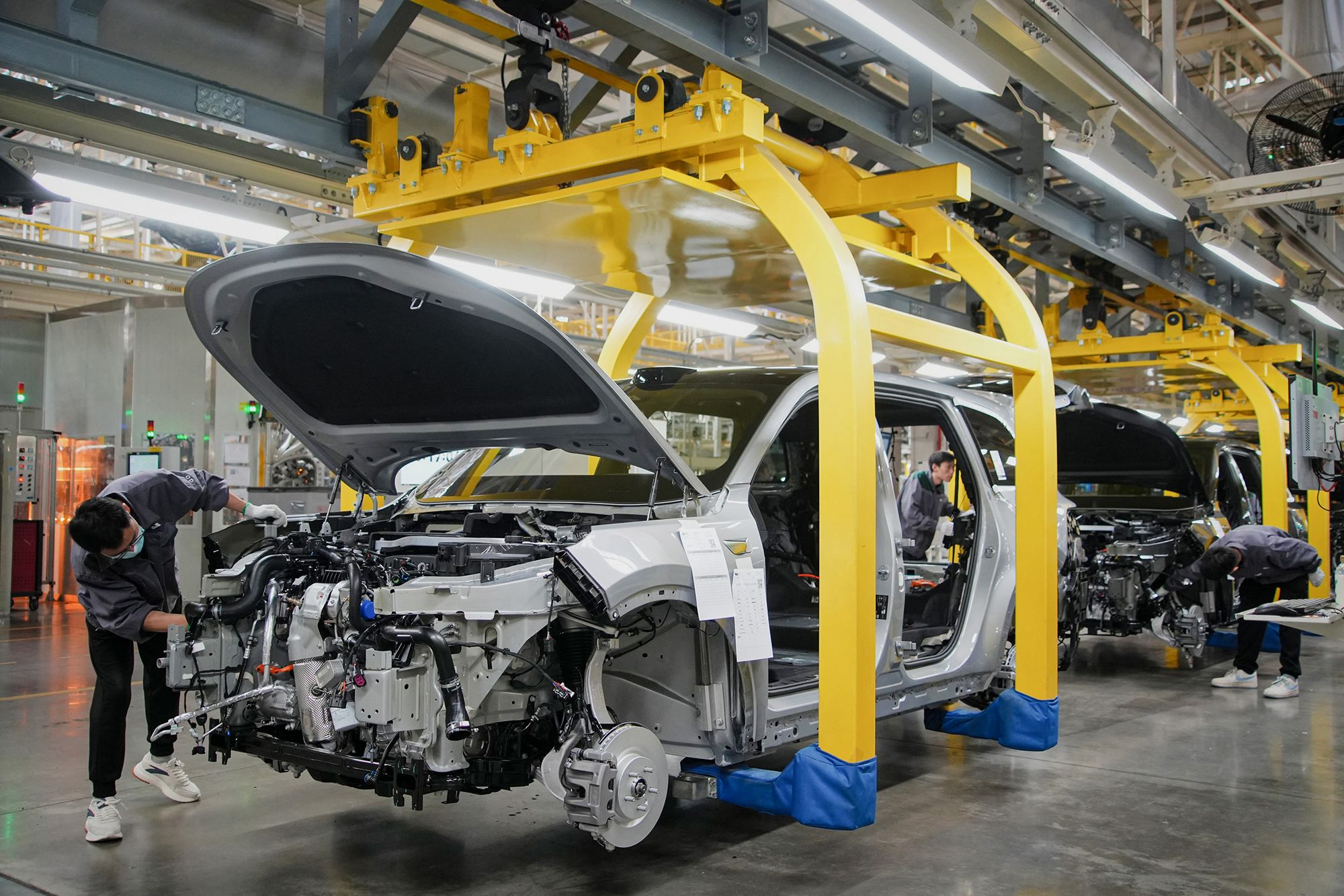 This photo taken on March 27, 2024 shows employees working on a car assembly line at a factory of Chinese carmaker Li Auto in Changzhou, in eastern China's Jiangsu province.