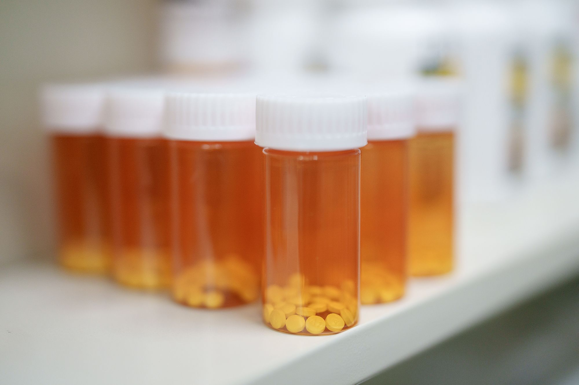 Medications are stored on shelves at a pharmacy.