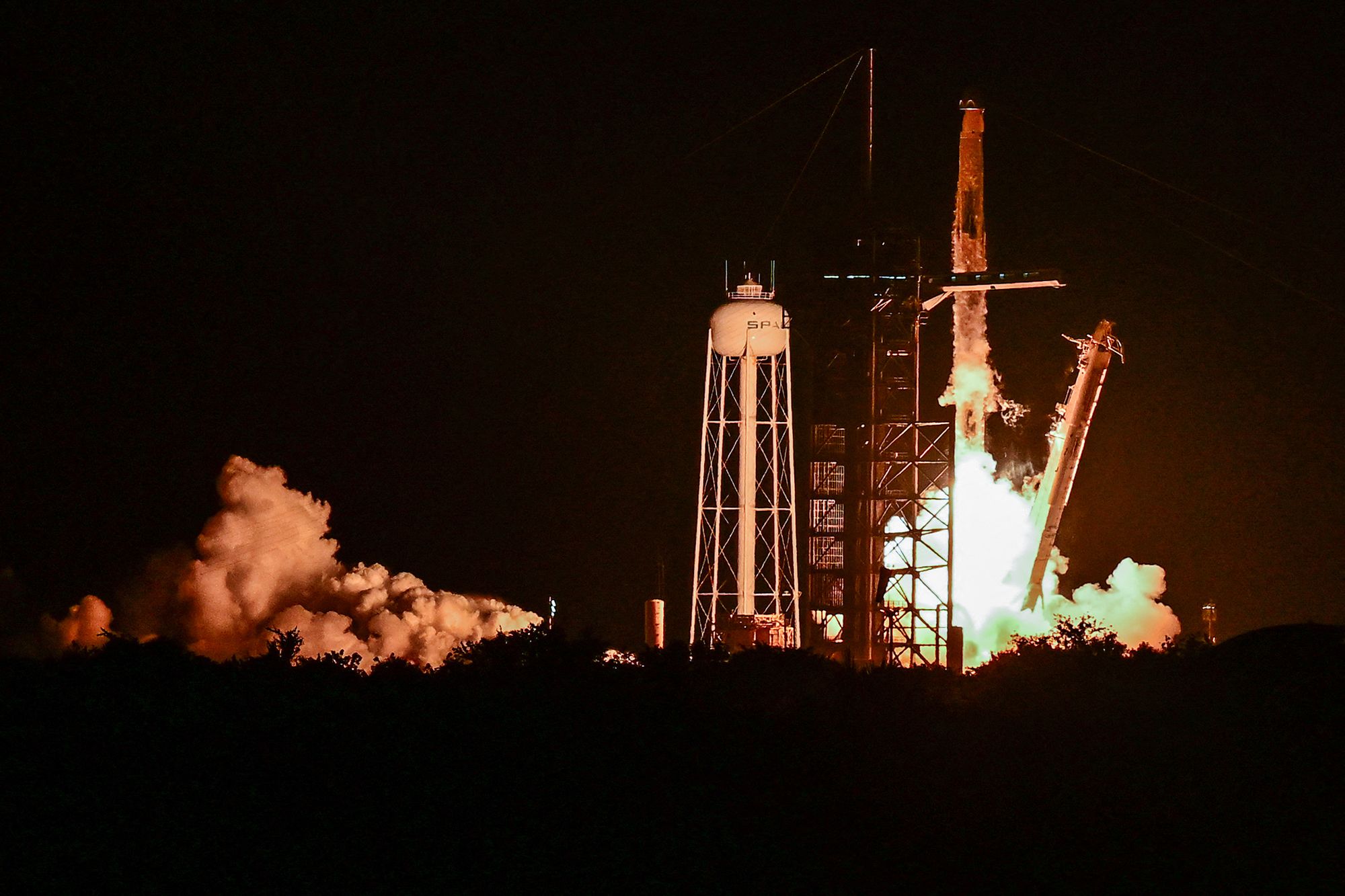 A SpaceX rocket lifts off from the Kennedy Space Center. The Elon Musk-owned space company has purchased another one of Musk's companies, artificial intelligence firm xAI, with plans to put a network of 1 million AI data centers into orbit.