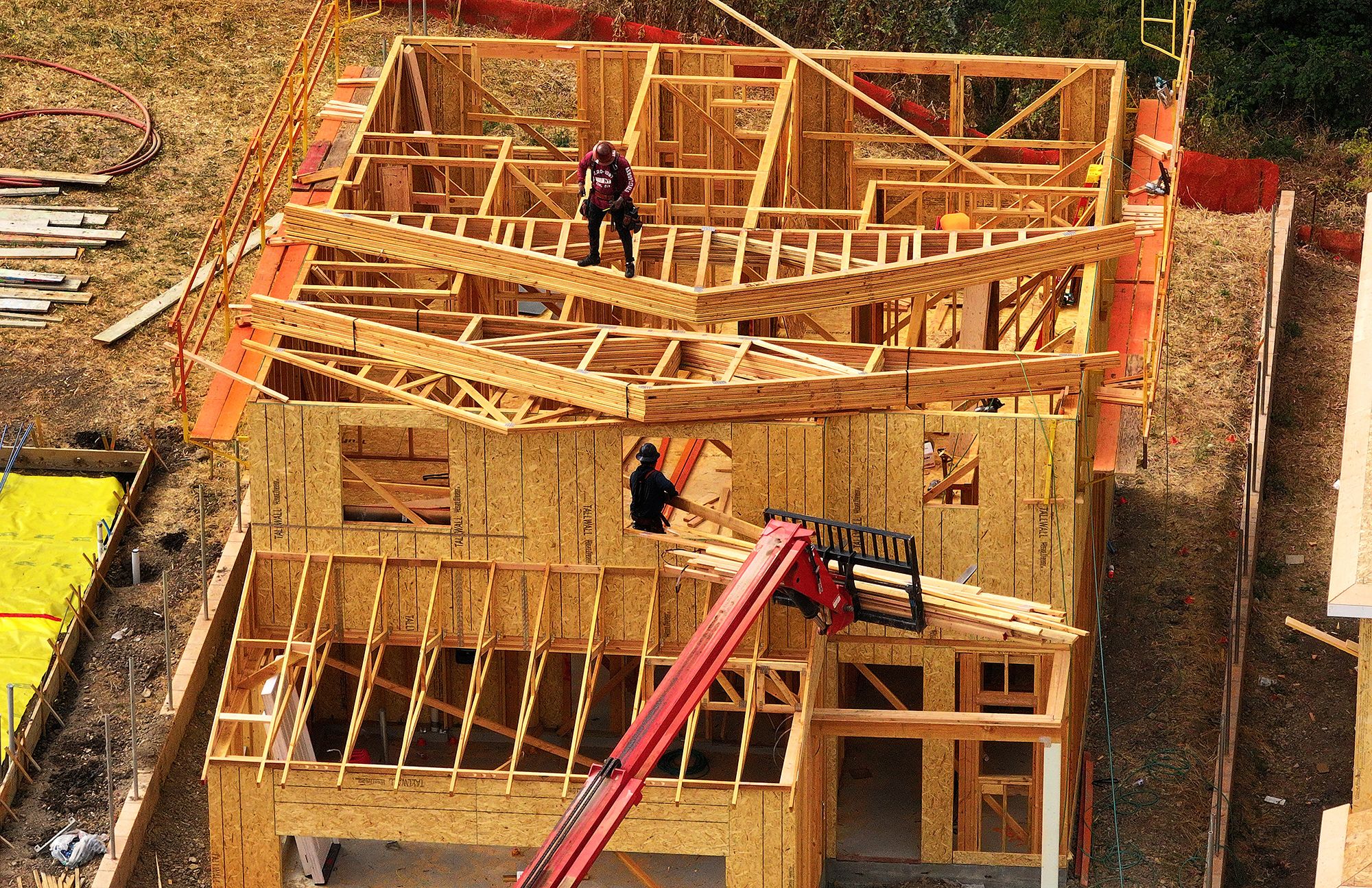 Construction workers build a home at a new housing development on July 1, 2025 in Hercules, California.