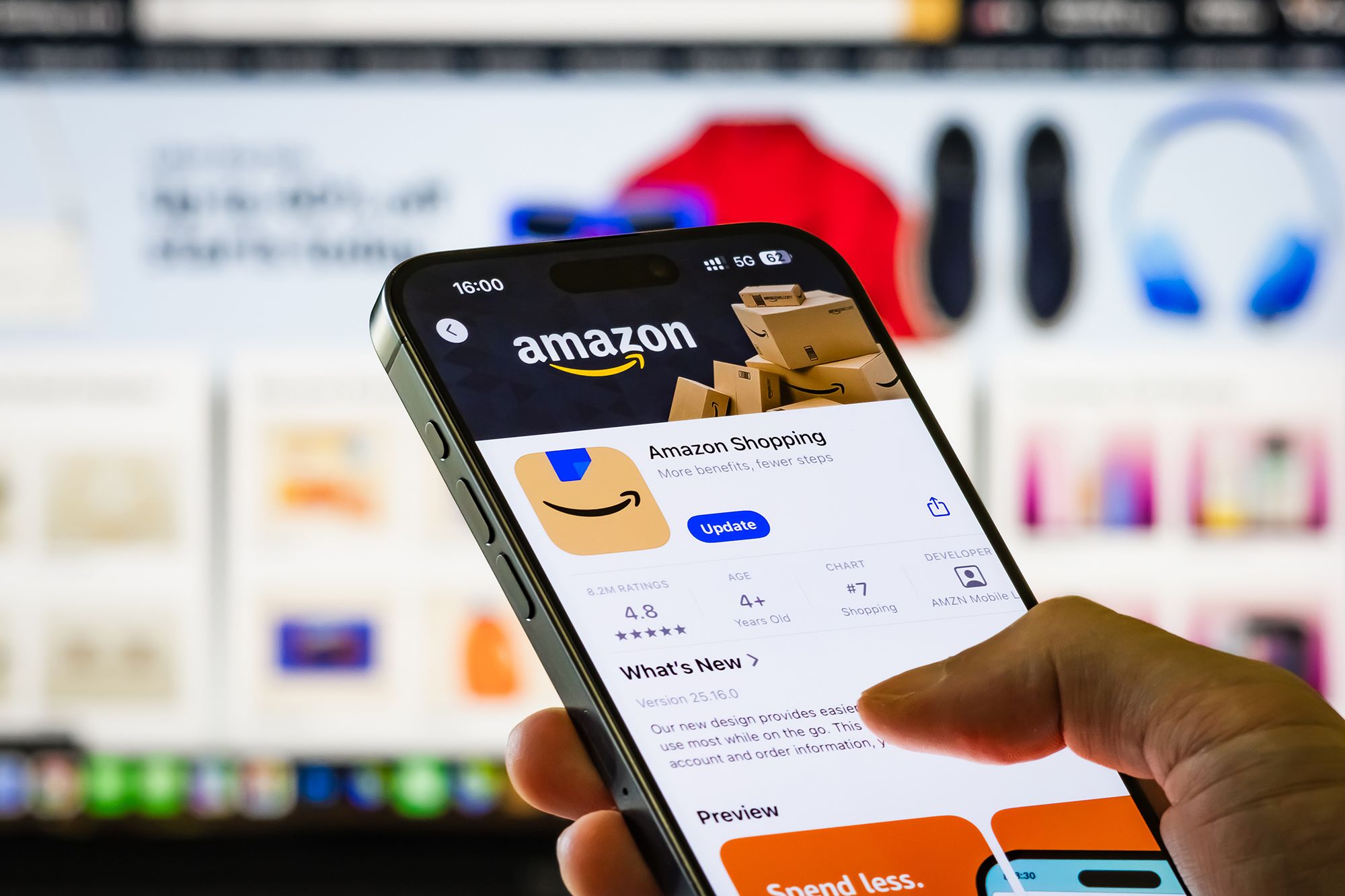 A person holds a smartphone showing the Amazon Shopping app page in the Apple App Store. The FTC and 22 states sued Amazon over advertising business practices on its vast e-commerce platform.