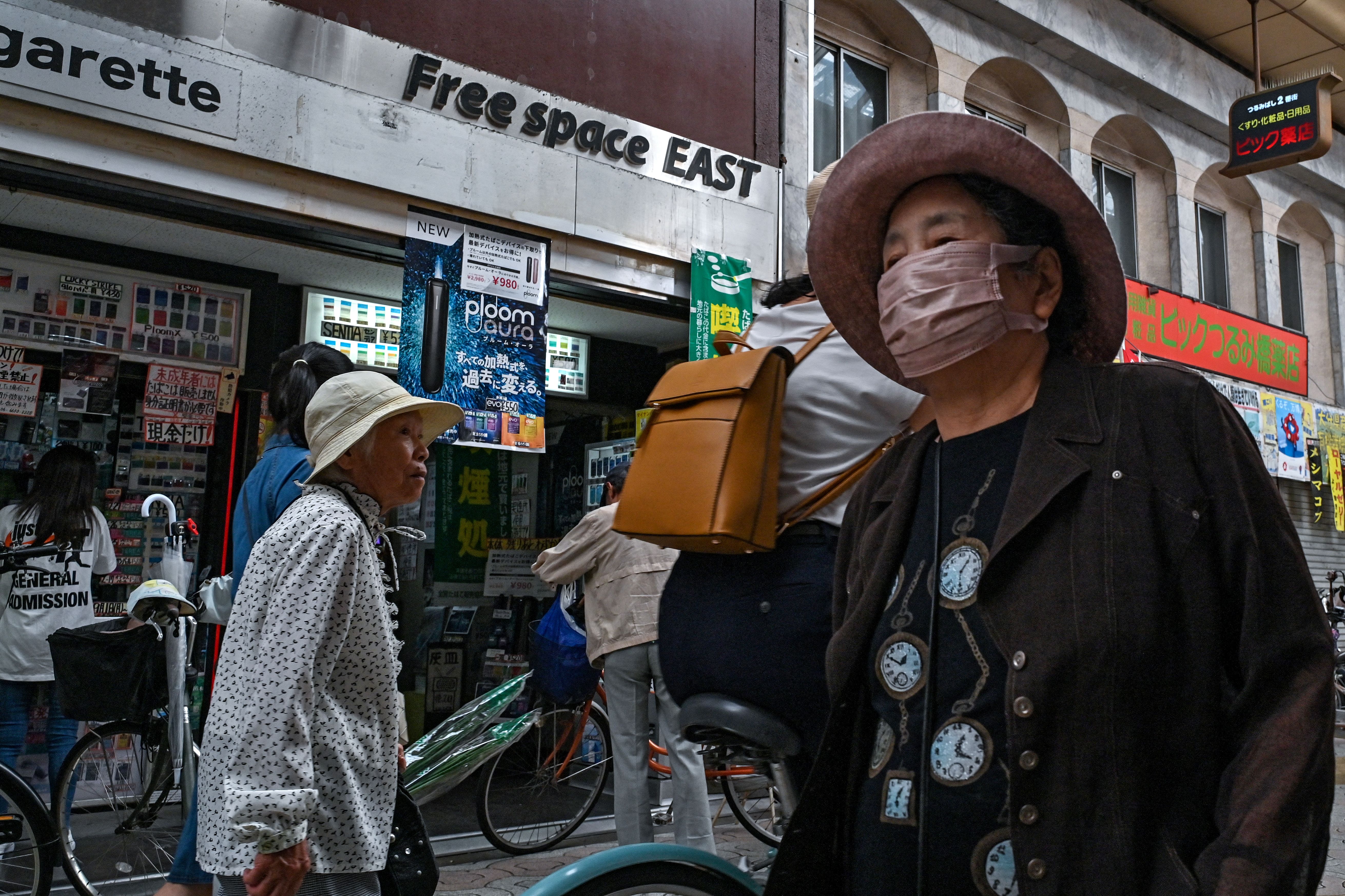 Elderly shoppers walking through the Tsurumibashi "shotengai", an old covered shopping street in the Nishinari ward of Osaka, Japan, on October 1, 2025.