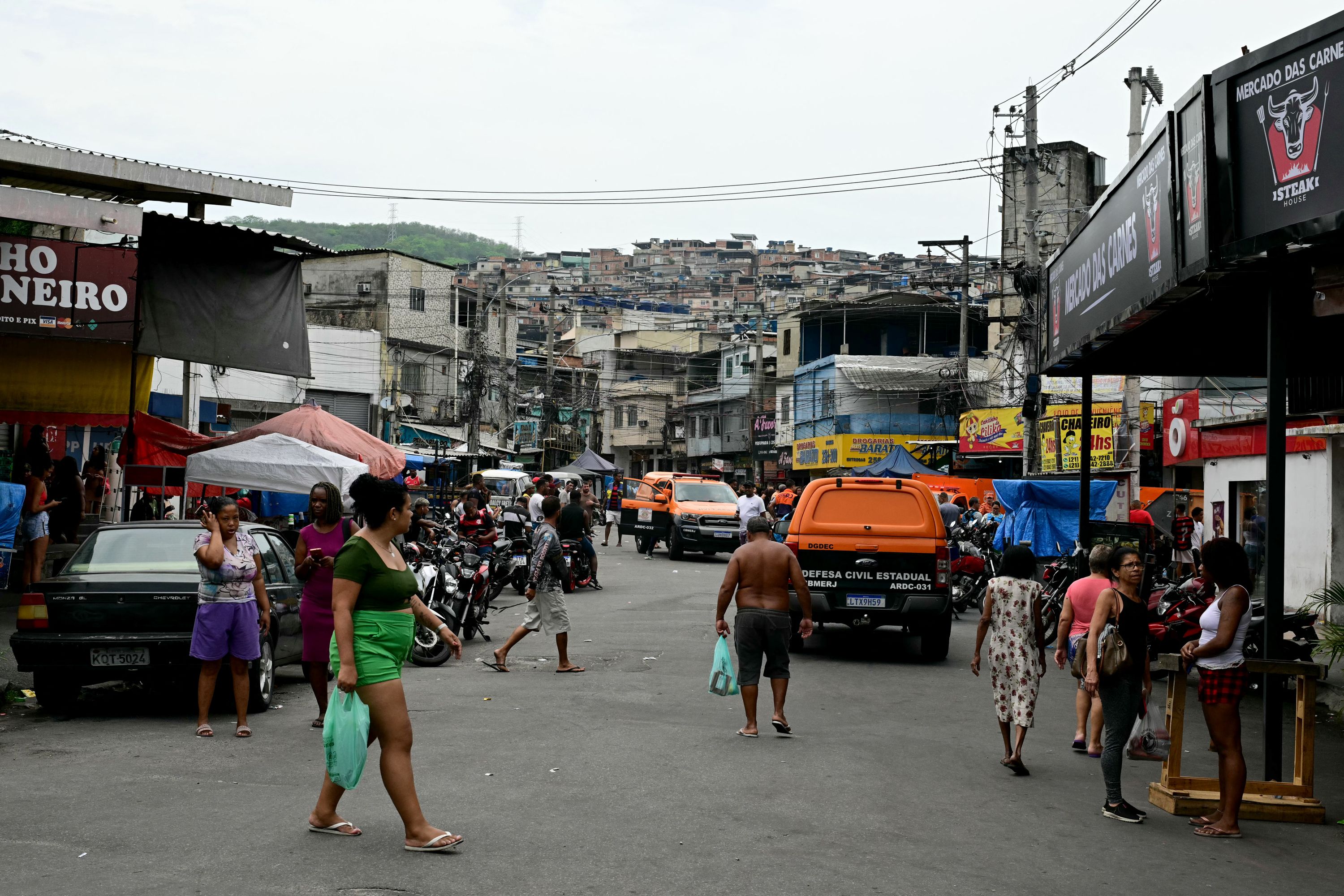 Civil Defense vehicles are seen on a street in the Vila Cruzeiro favela at the Penha complex in Rio de Janeiro, Brazil, on October 29, 2025, in the aftermath of Operacao Contencao (Operation Containment). Residents of a favela in Rio de Janeiro lined up more than 50 bodies at a plaza in their low-income neighborhood on Ocotber 29, a day after the bloodiest police operation in the city's history, AFP reported. (Photo by Pablo PORCIUNCULA / AFP) (Photo by PABLO PORCIUNCULA/AFP via Getty Images)