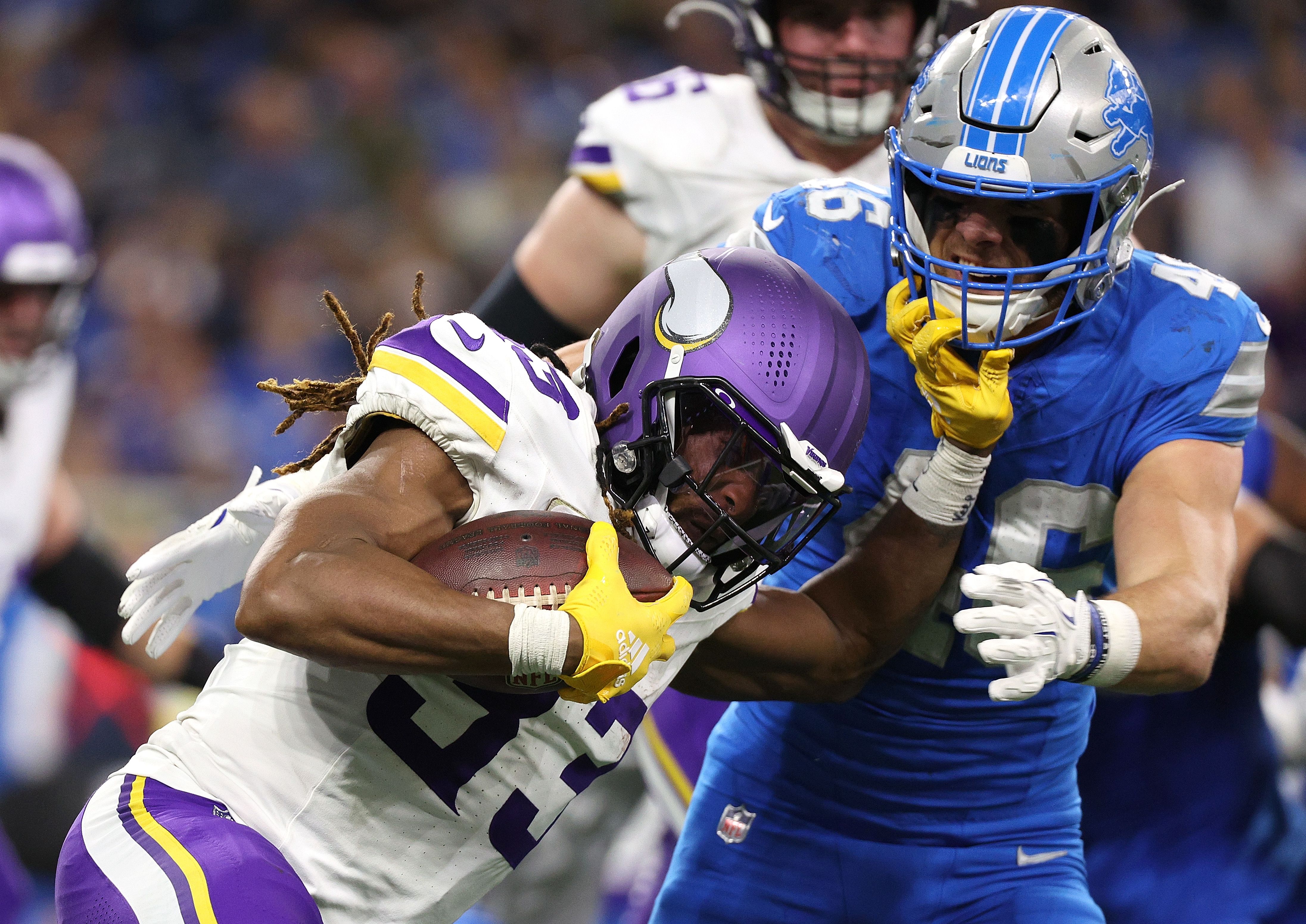 DETROIT, MICHIGAN - NOVEMBER 02: Aaron Jones Sr. #33 of the Minnesota Vikings is tackled by Jack Campbell #46 of the Detroit Lions in the second quarter in the game at Ford Field on November 02, 2025 in Detroit, Michigan. (Photo by Mike Mulholland/Getty Images)