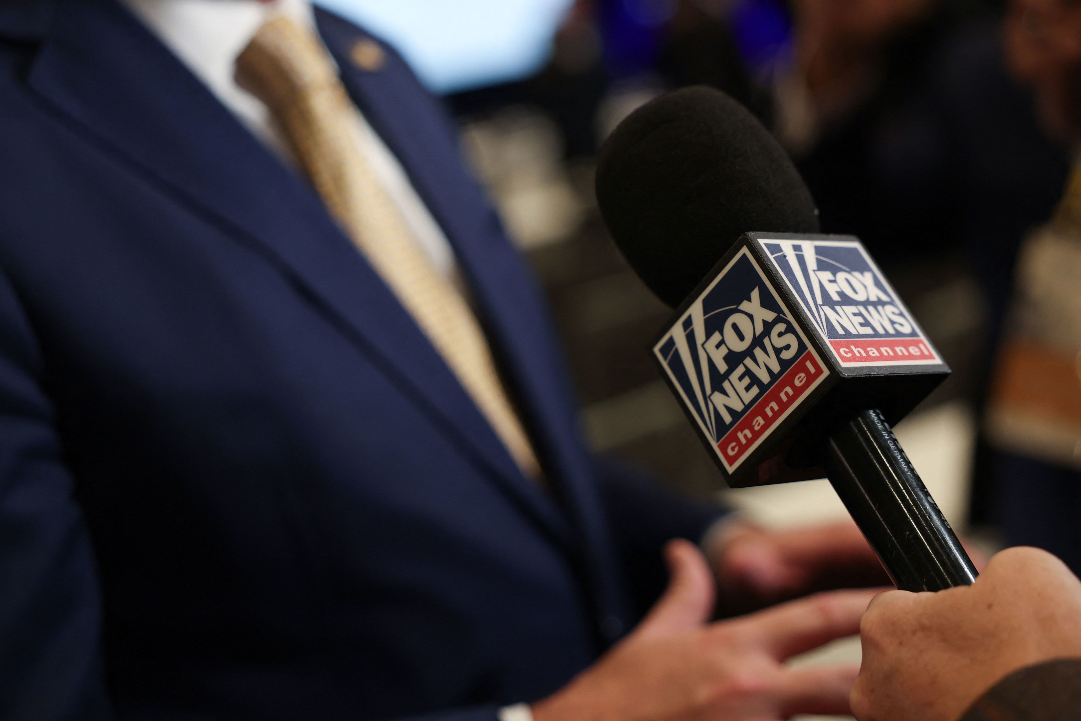A Fox News journalist holds their microphone during the Republican National Committee (RNC) Winter Meeting in Santa Barbara, California, on January 23, 2026.