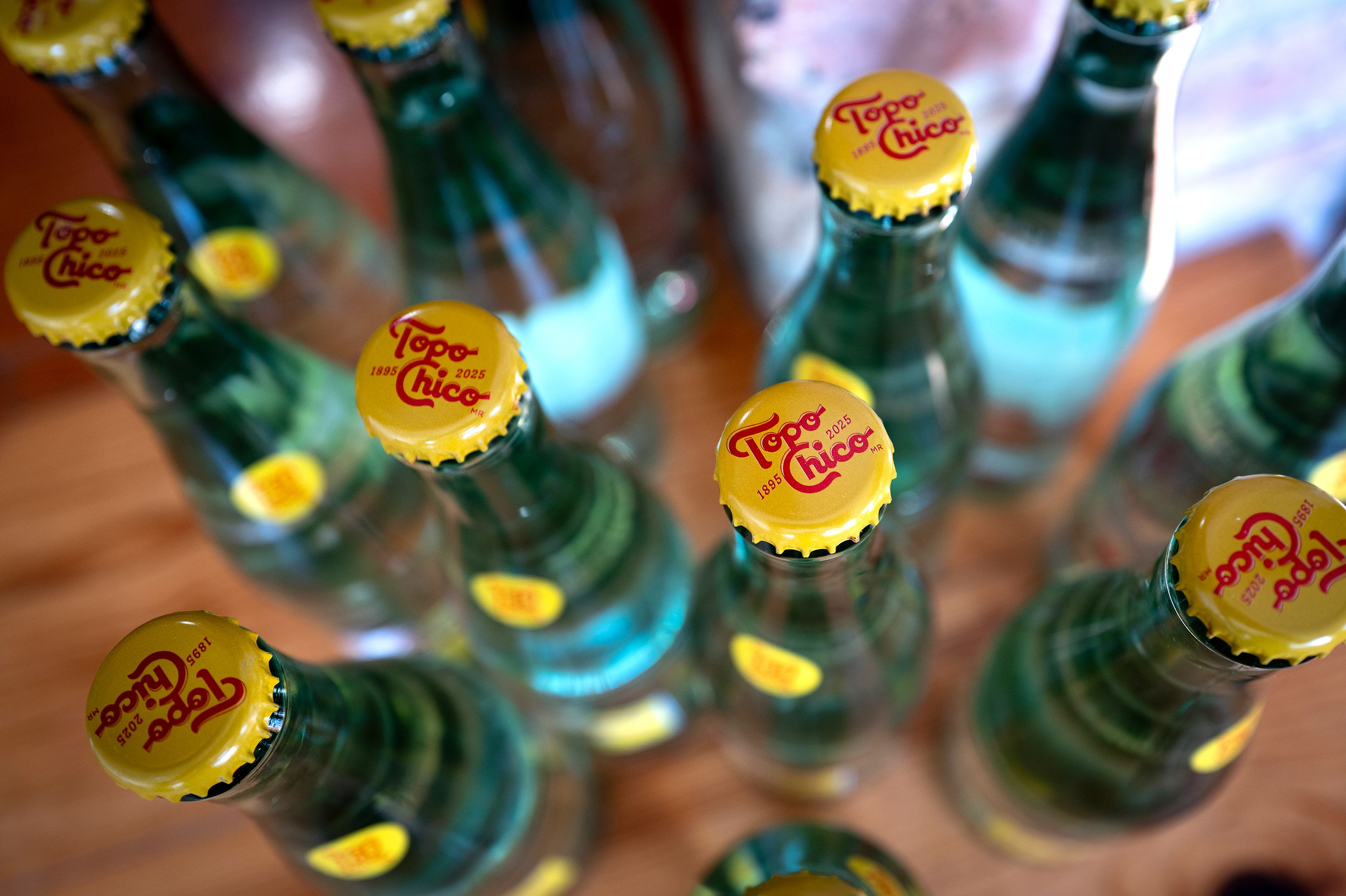 In this photo illustration, bottles of Topo Chico carbonated mineral water are shown on February 23, 2026 in Chicago, Illinois. Coca-Cola, which purchased Topo Chico in 2017 for $200 million, expects shortages of the water in the United States to last through the third quarter of the year as it works on facility upgrades at the source in Monterrey, Mexico.
