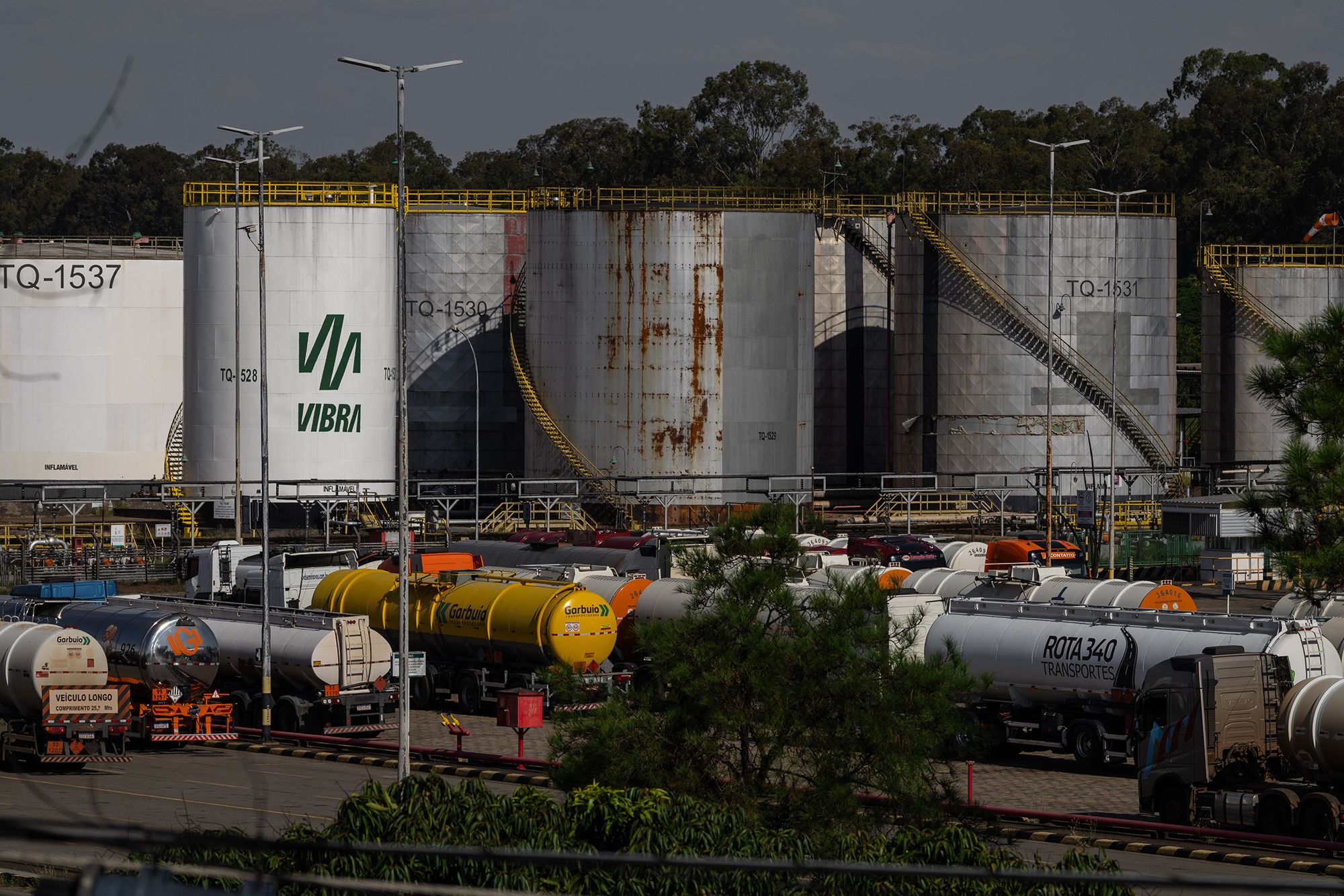 Trucks near oil storage tanks at a Petrobras refinery in Paulinia, Brazil. Oil exports have risen in the wake of the US-Iran war.