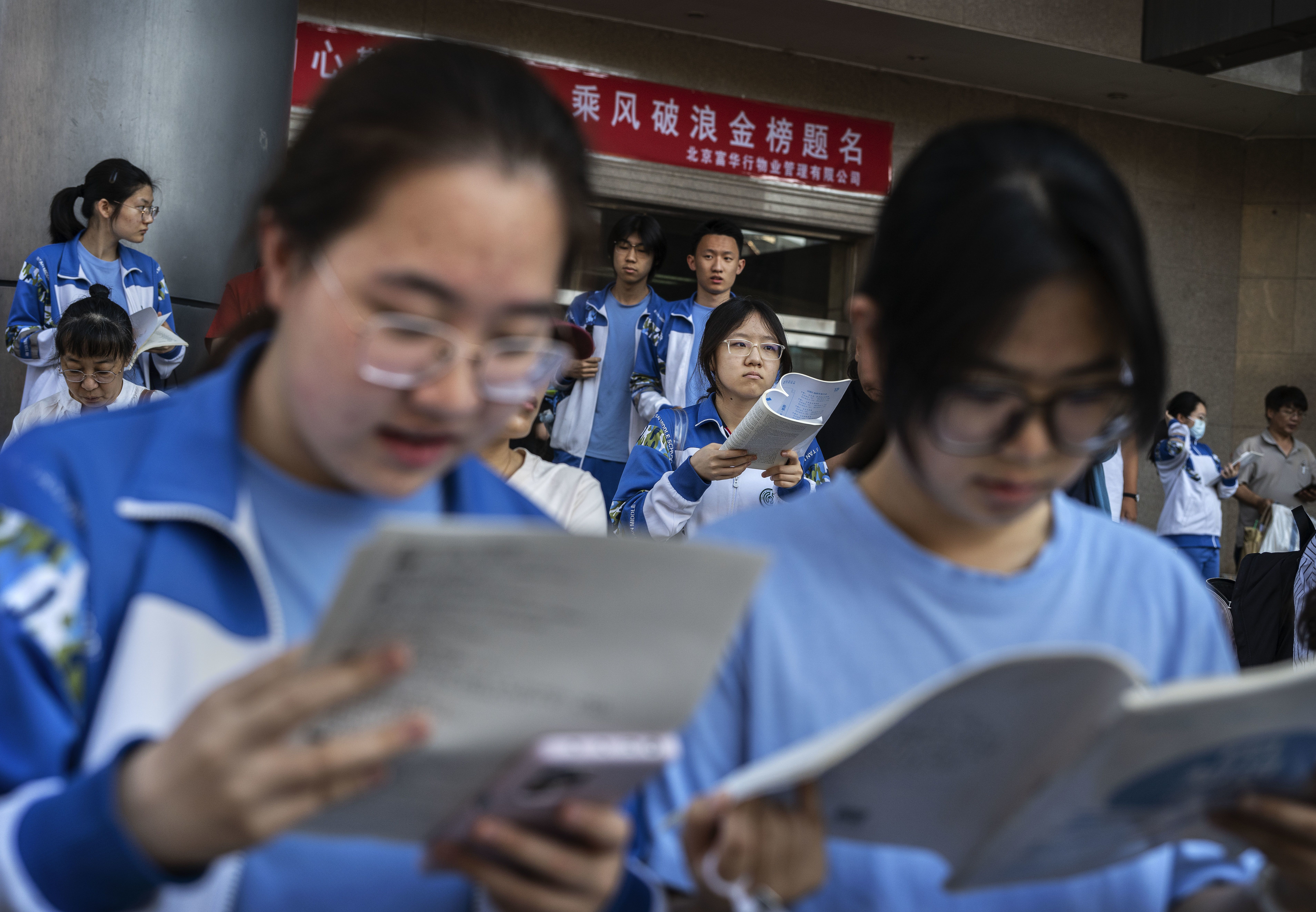 Students review and study as they await to enter to take the annual National College Entrance Examination, known as the Gaokao, at the Beijing Chenjinglun High School on June 7, 2026 in Beijing, China.