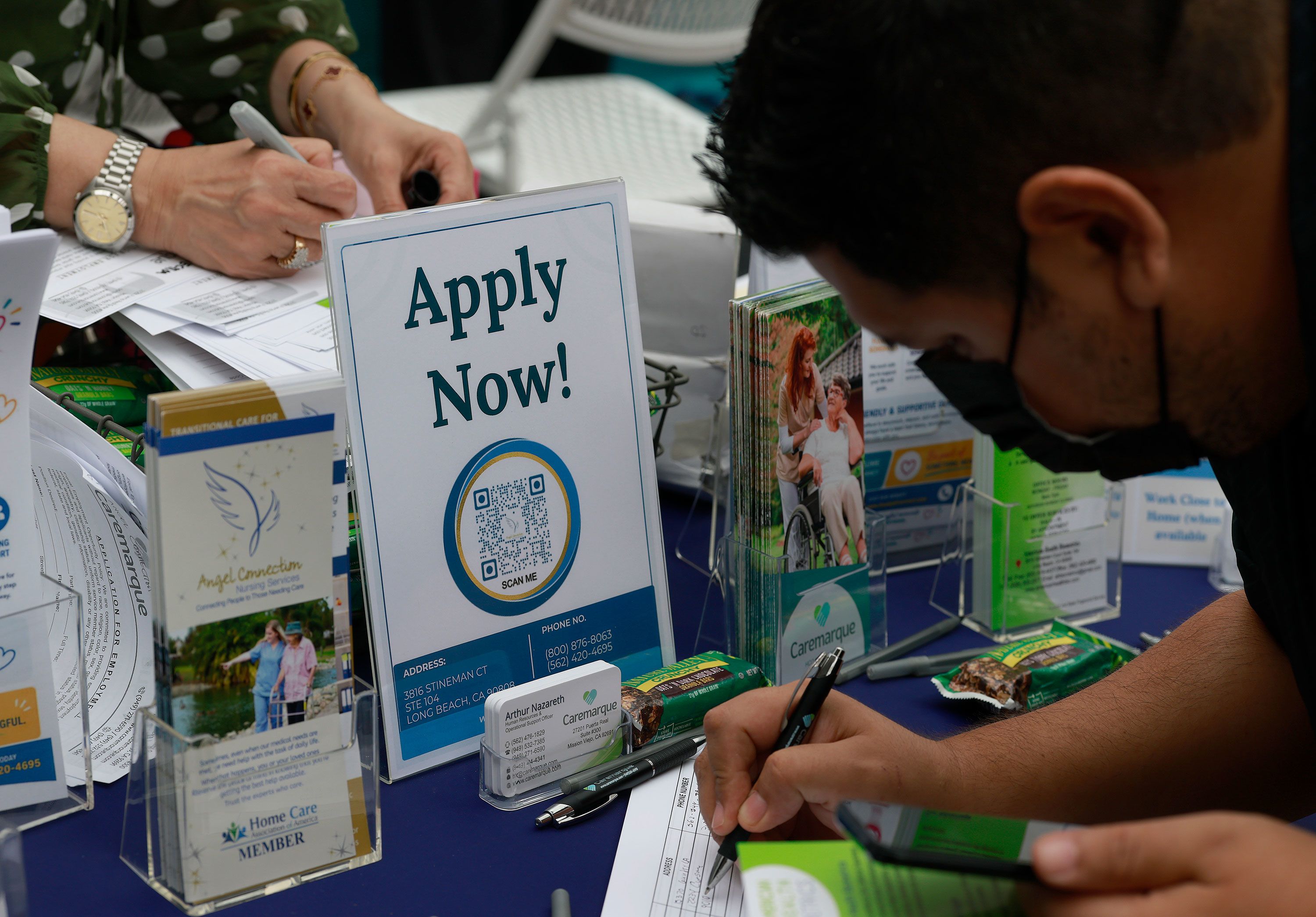 A job seeker fills out a request for information during a job fair in Carson, California, on June 30, 2026,