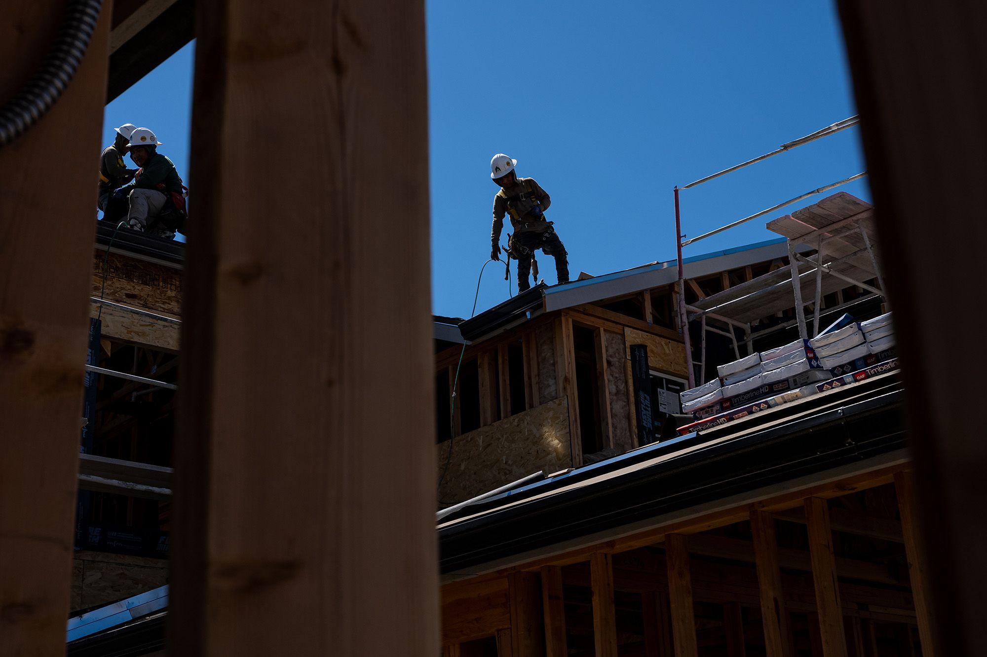 Workers apply roofing material to a home under construction at the Lilac Ridge community by Lennar Homes in Vacaville, California, US, on Tuesday, July 14, 2026.