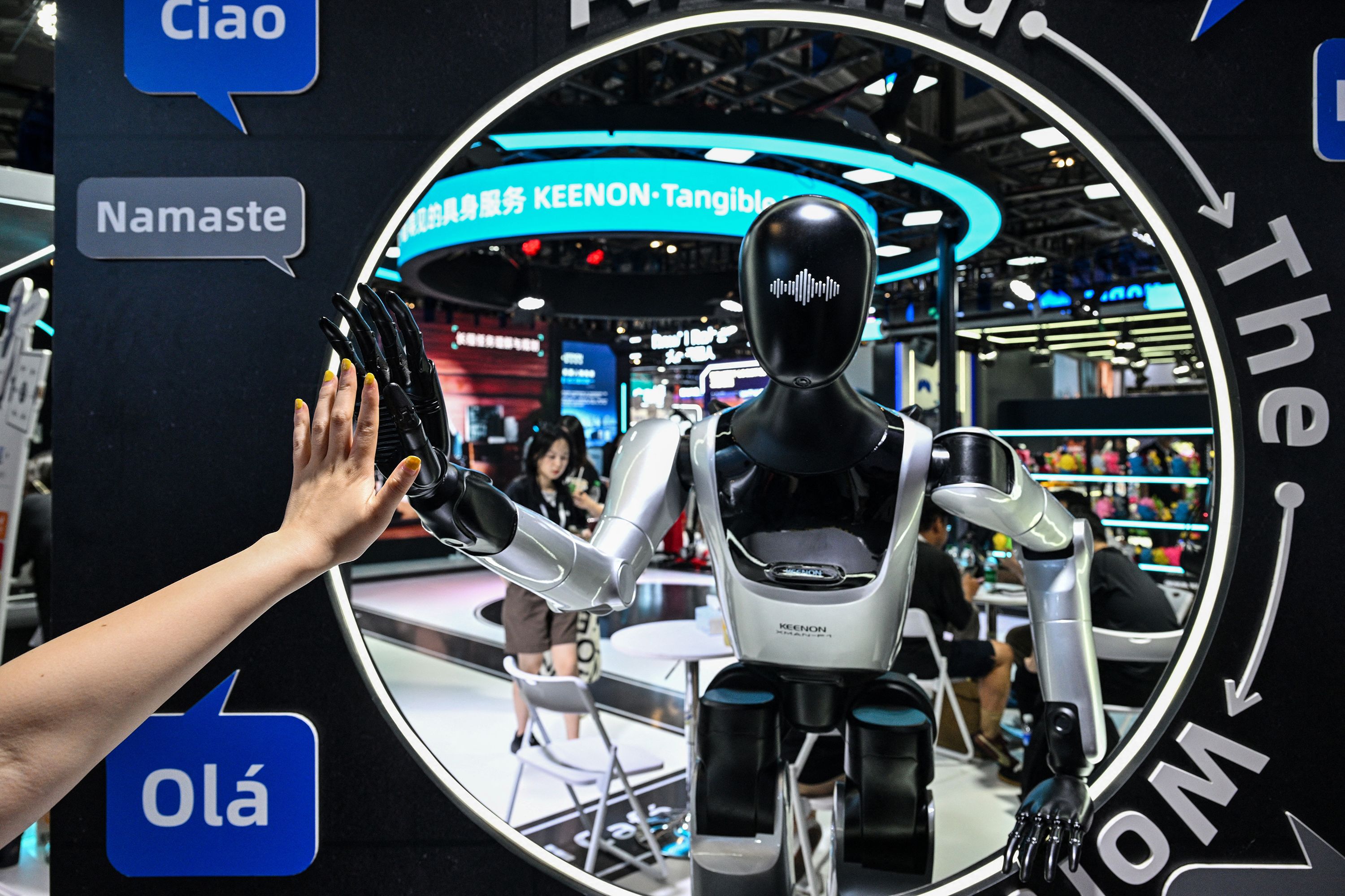 A woman touches a humanoid robot during the World Artificial Intelligence Conference in Shanghai on July 18.