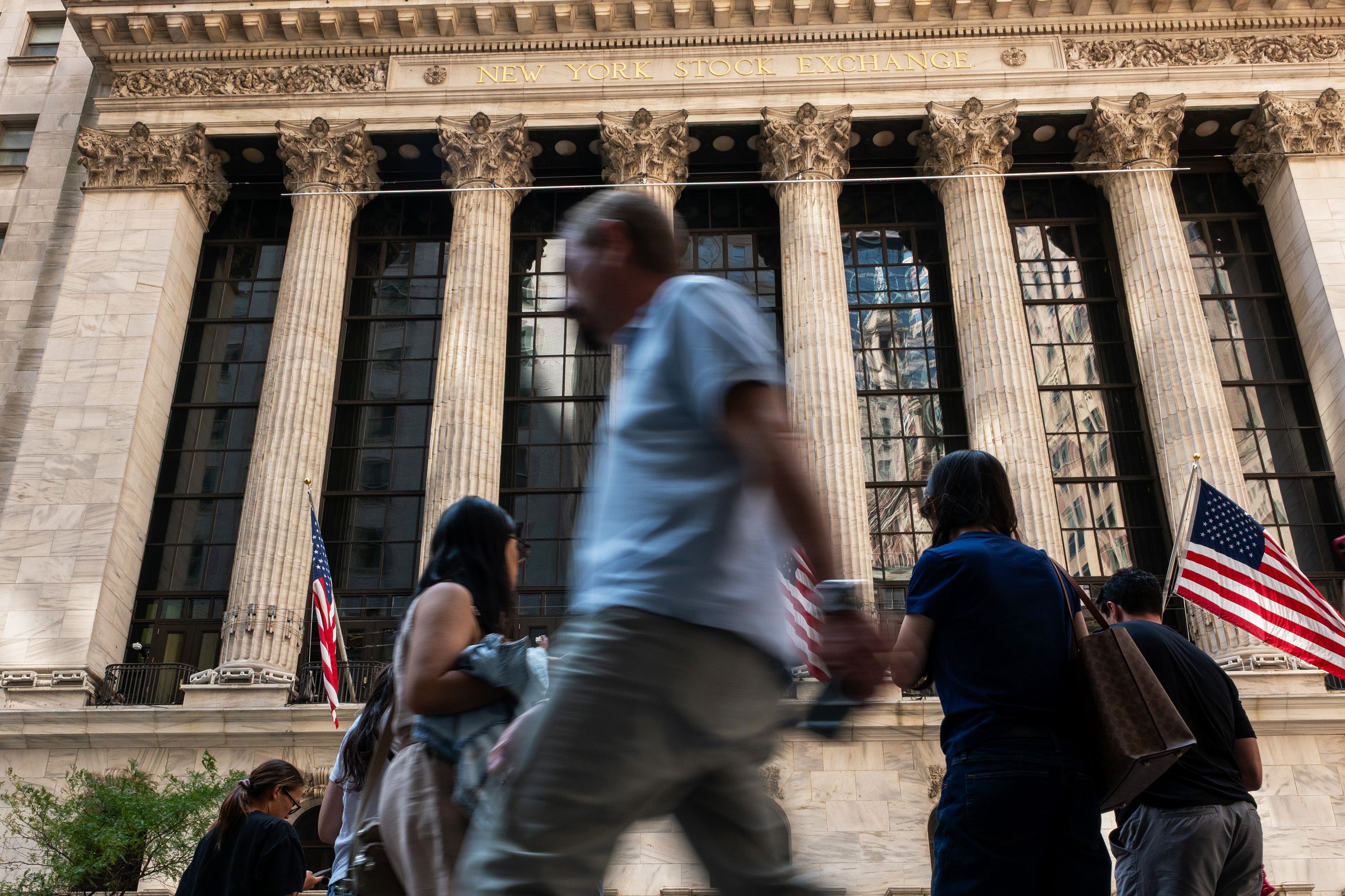 People walk by the New York Stock Exchange (NYSE) on July 23, 2026 in New York City. Stocks fell sharply in afternoon trading as oil prices surged around the world as the conflict between the United States and Iran continues.