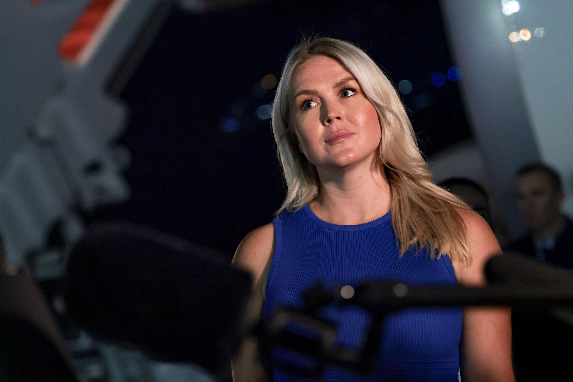 White House Press Secretary Karoline Leavitt looks on as President Donald Trump speaks to reporters after stepping off Air Force One on August 11, 2026.