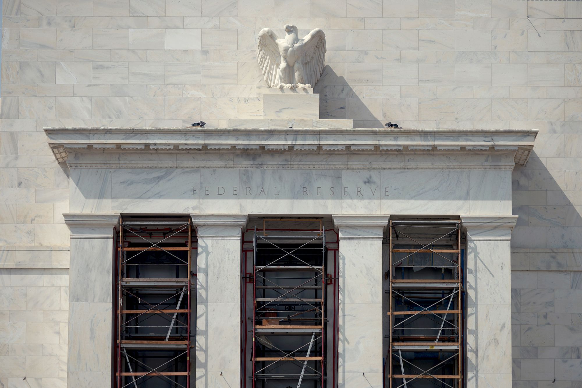 A marble American eagle sculpture sits atop of the Marriner S. Eccles Federal Reserve Board Building in Washington, D.C., on August 13.