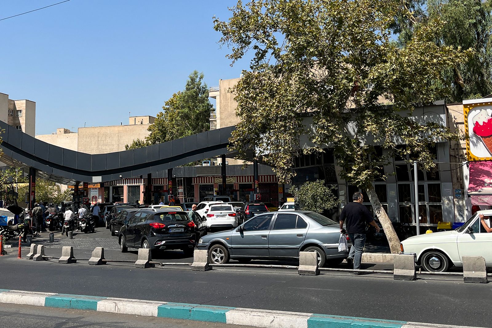 Drivers queue at a petrol station to refuel in Tehran, on August 25, 2026.