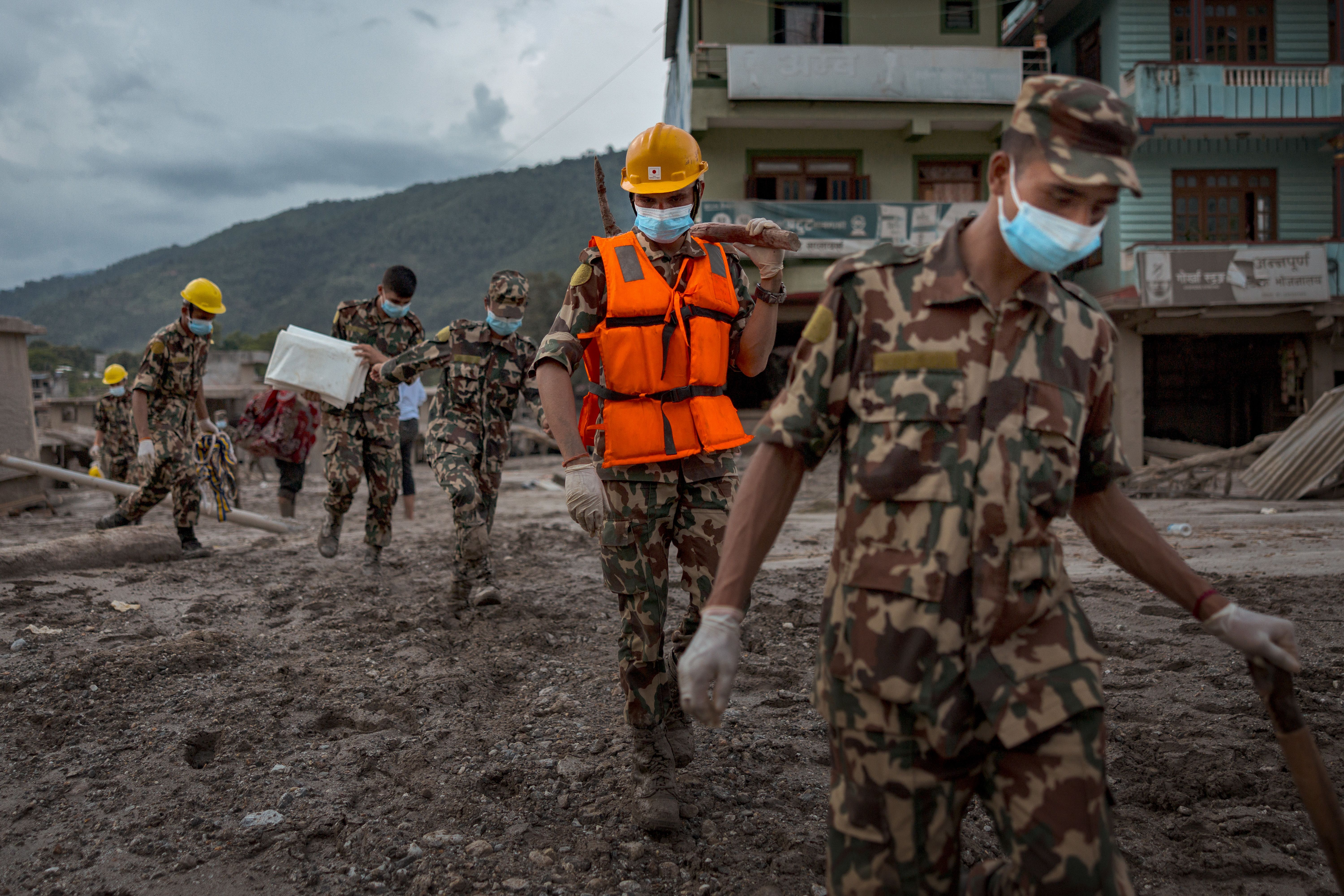 Soldiers search for bodies as rescue operations shift into search and retrieval, following flash floods on August 29, 2026 in Devighat, Nepal. A sudden flood swept through the Bhote Koshi River basin in northern Rasuwa on August 26, damaging settlements, roads and energy infrastructure as rescue teams searched for residents and foreign travellers reported out of contact. Hundreds were reported missing, as the death toll started to climb.