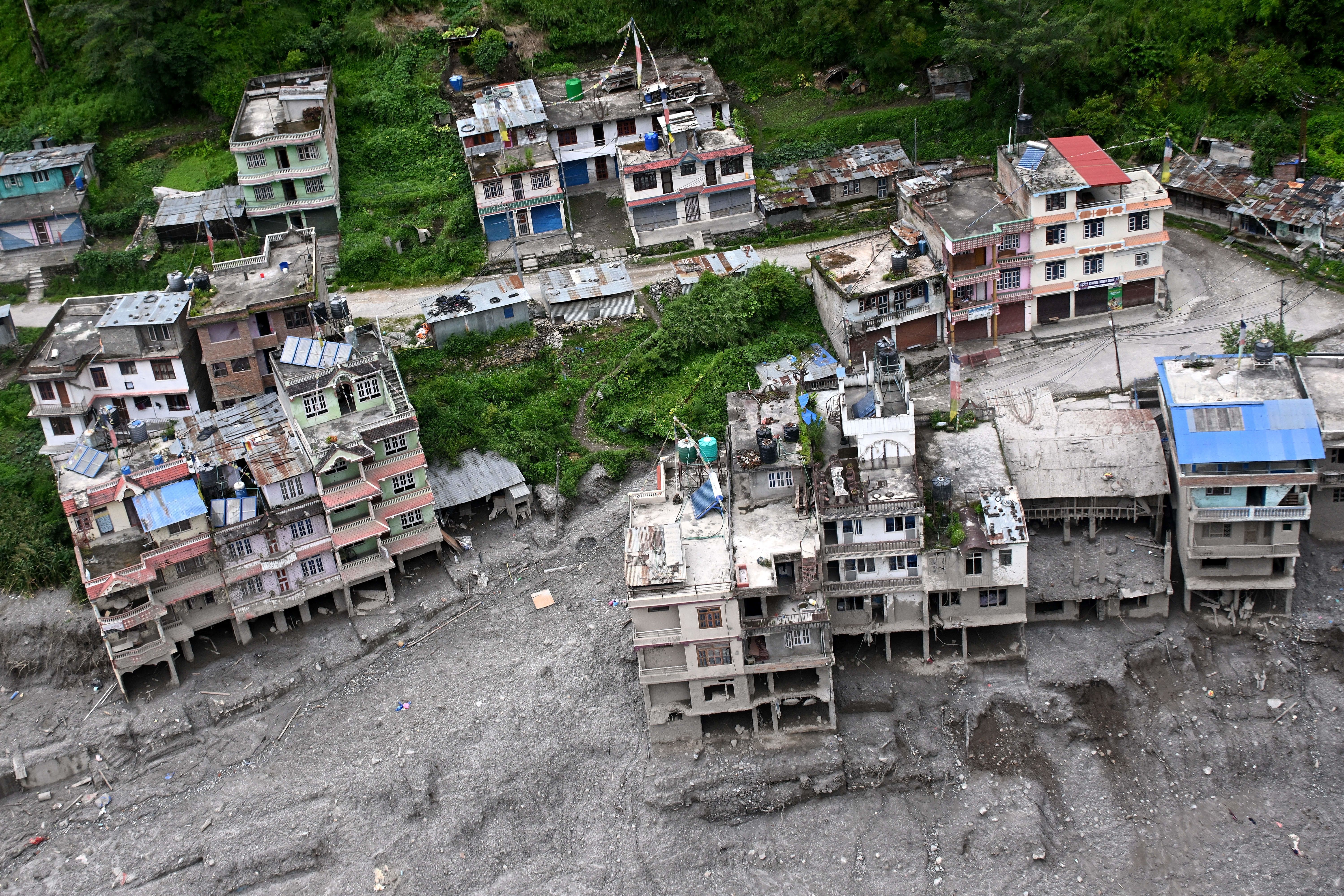 An aerial view shows houses damaged and deluged in sludge in the aftermath of flash floods at Syabrubesi in Nepal's Rasuwa district on September 3, 2026.