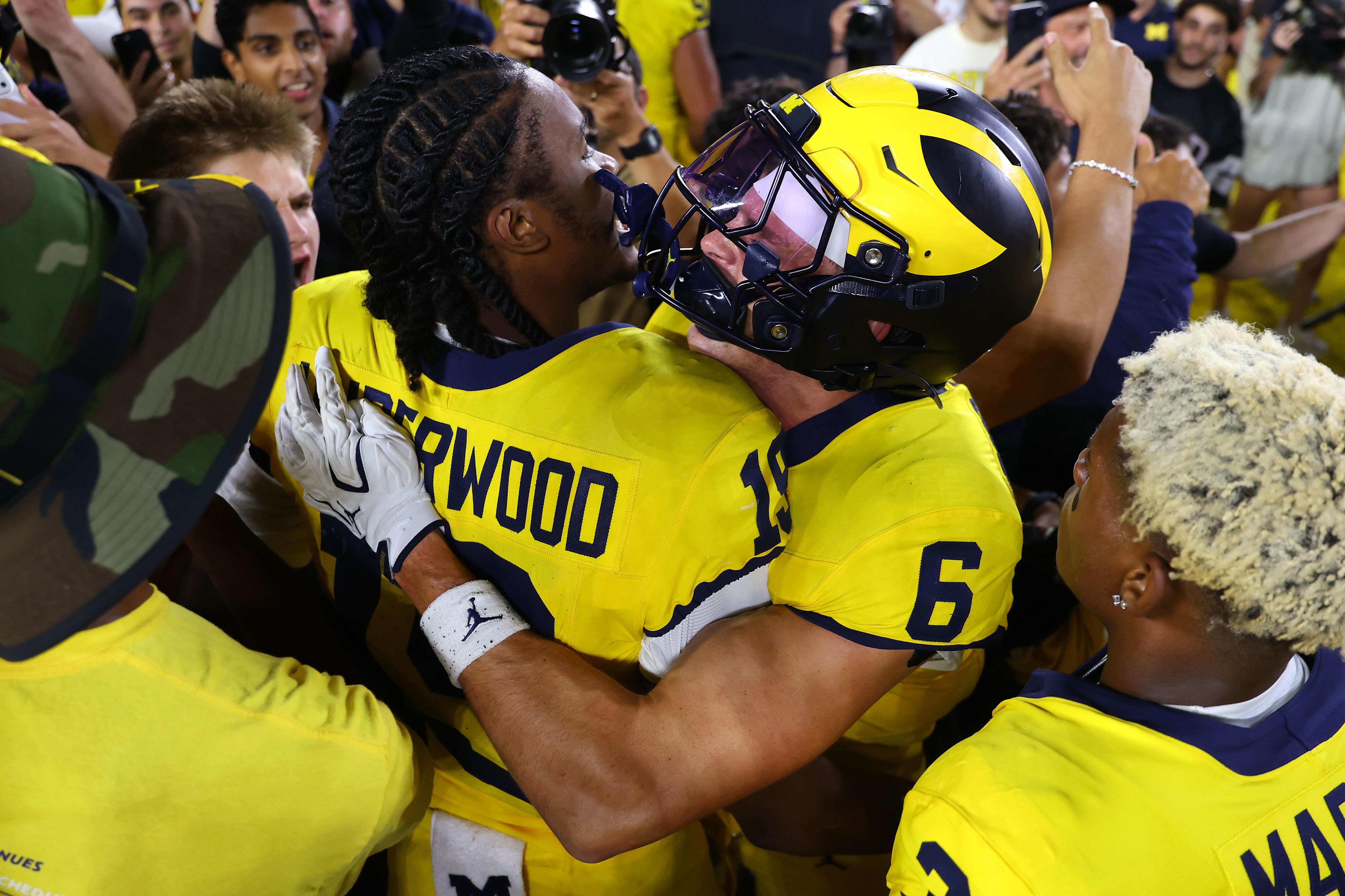 Bryce Underwood and JJ Buchanan celebrate Michigan's 13-12 win over Western Michigan on Saturday.