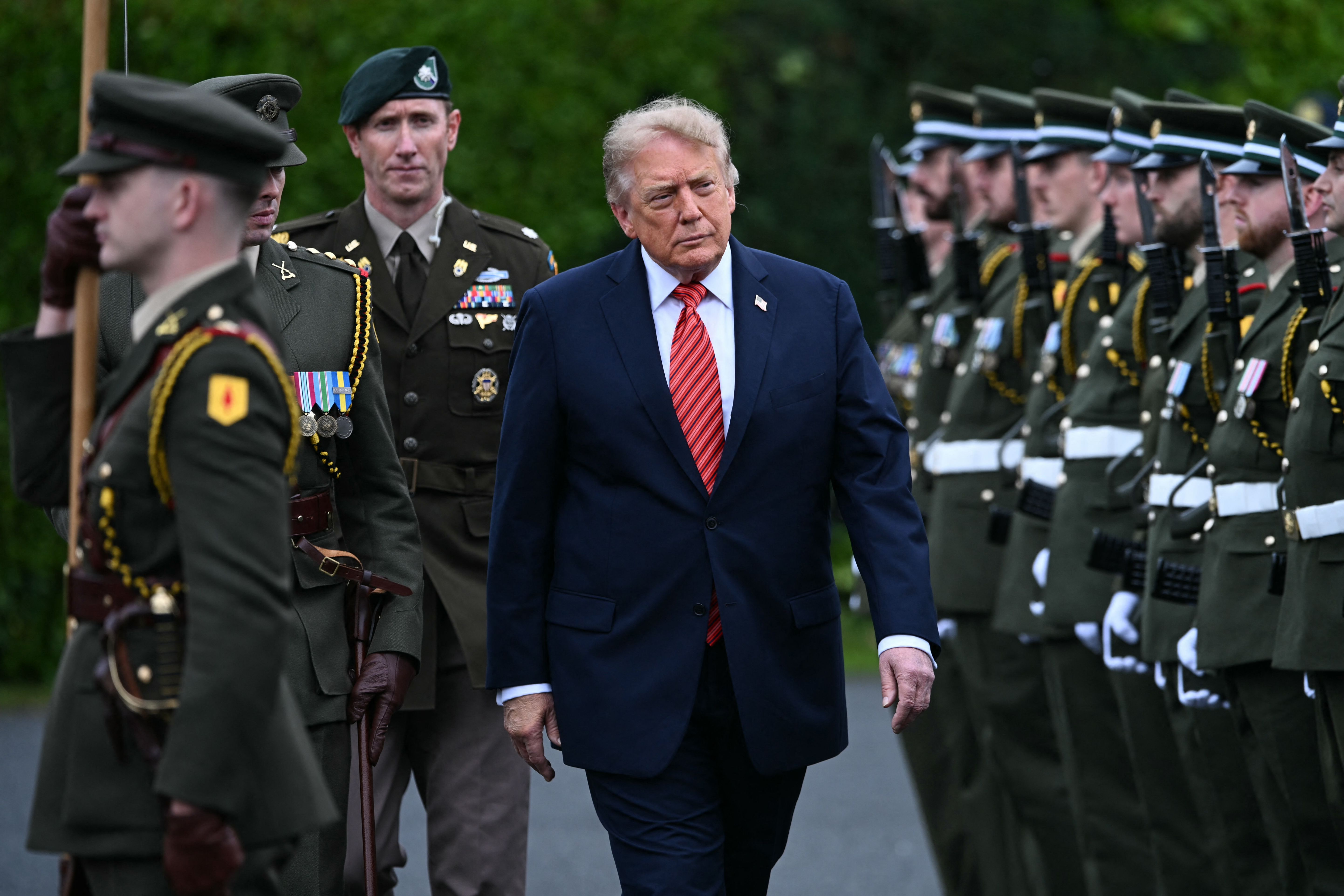 US President Donald Trump inspects an honor guard as he attends a welcoming ceremony at Áras an Uachtaráin in Phoenix Park in the Irish capital Dublin on September 12, 2026.